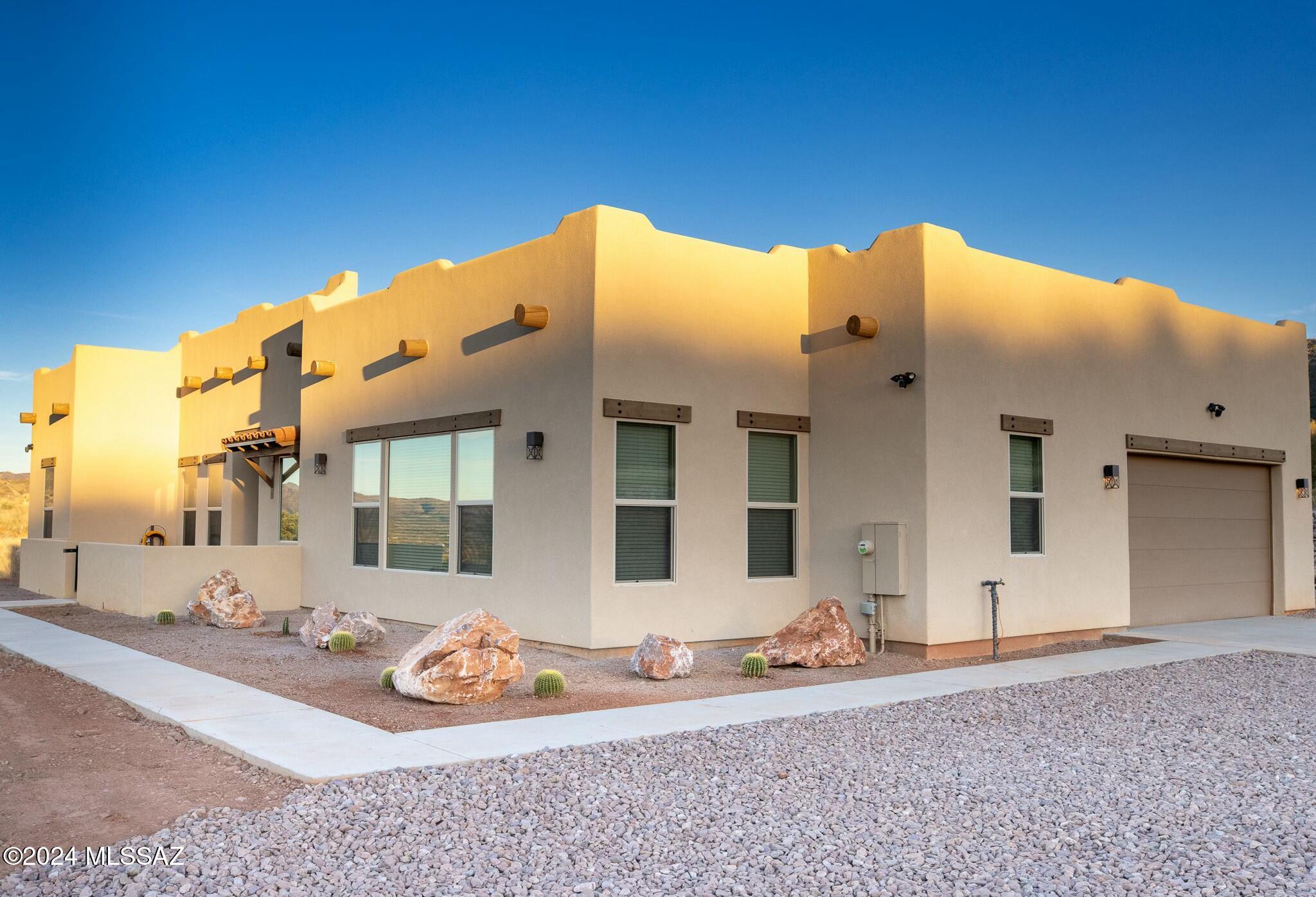 This custom hilltop home in the prestigious gated community of The Mesa offers stunning views from every room and combines privacy with proximity to Patagonia. It features 3 bedrooms, 2.5 bathrooms, and a versatile den perfect for various uses. The open floor plan includes a gas fireplace, expansive windows with upgraded blinds, and sleek tile flooring. The gourmet kitchen is equipped with a large island, pantry, soft-close cabinets, and stainless-steel appliances. Outside, the well-maintained landscaping enhances the home's curb appeal, providing a perfect backdrop for enjoying the breathtaking views. Don't miss the chance to make this exceptional property your own!