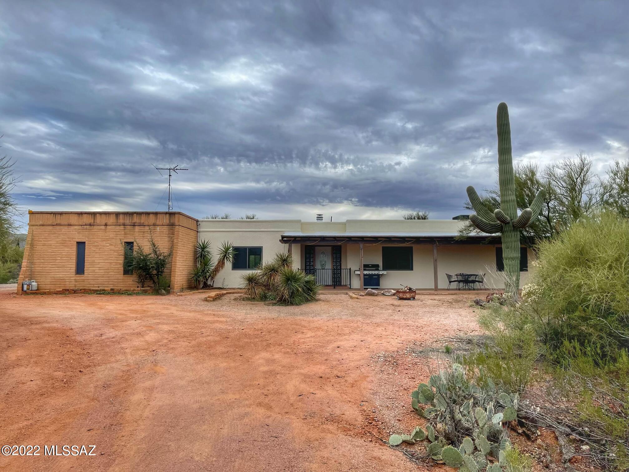 Seller will accept/entertain offers between $600K-650K. Welcome home to your peaceful and private, desert escape! As you make your way to this 4.4+ acre horse property, you'll be greeted with breathtaking panoramic mountain views. This 4 bedroom, 3 full bath home offers a split floor plan with dual masters, Saltillo tile throughout, updated bathrooms, and kitchen with SS appliances, and expanded storage. Additional features also include a large Arizona room, partially enclosed back patio, 4 horse stalls and tack room. Property is being sold ''as-is'' and has some minor deferred maintenance but with a little TLC this is a fantastic opportunity to own a slice of Arizona living!