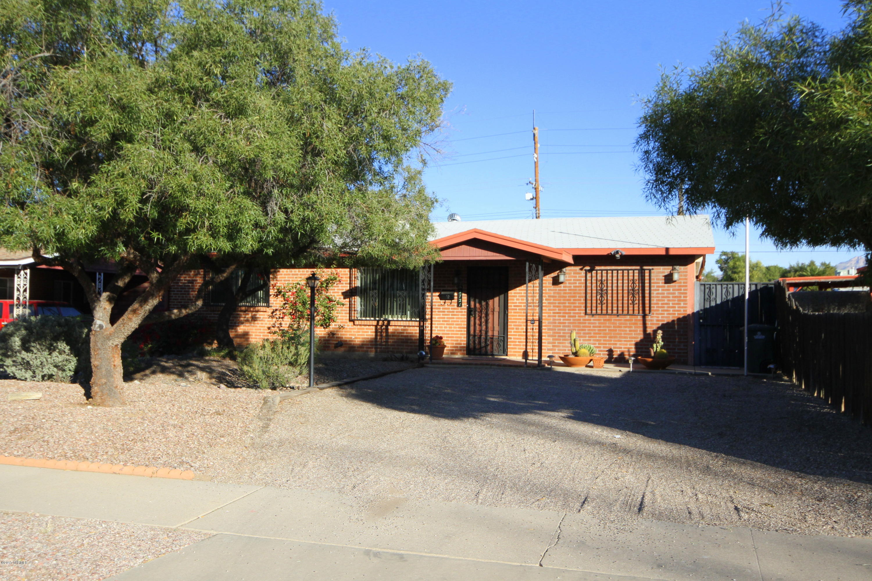 This Charming, Bright 2 bedroom home is easy walking distance from Reid Park, Reid Park Zoo, Hi Corbett Field, Randolph and Dell Urich Golf Courses. public transportation, shopping and grocery stores.  It features a
large family room with fireplace, separate den that can easily be turned into a 3rd bedroom with its own side entrance, upgraded dual pane windows and storage areas galore. Over sized two car detached garage with alley entrance and a totally walled in backyard great for entertaining, or just relaxing.