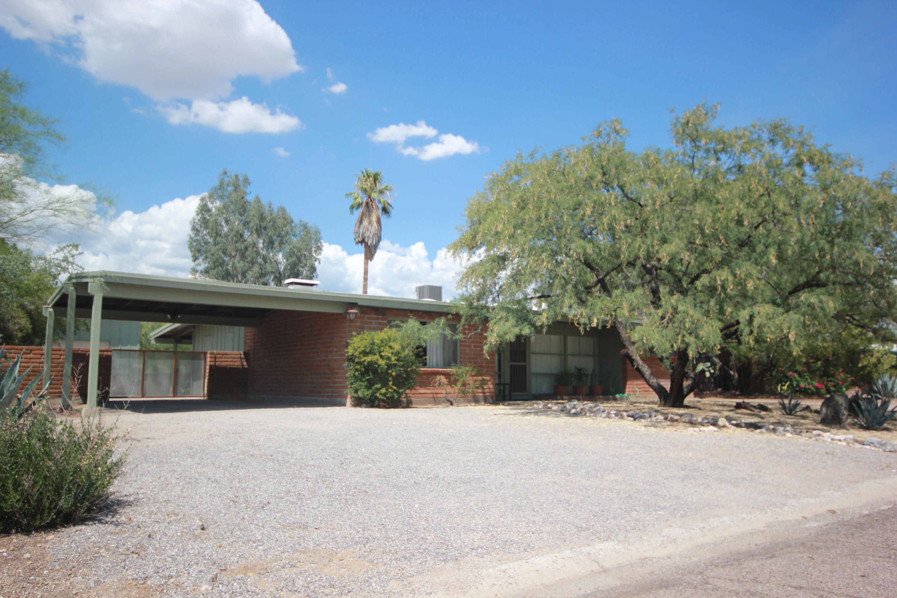 This is the one to see you hipsters!  Rare Mid-century burnt adobe in Indian Ridge Estates.  Original detailing with modern enhancements. 6'' concrete tile in large entry with wall of windows. Tall ceilings feature exposed beams with skylights. Two way burnt adobe fireplace with built in's.  Large living spaces surround a galley kitchen that can be used the way your family lives.  Well constructed one car garage with extra space and upgraded electrical.  Plenty of storage for bikes, hobbies or art space. No deferred maintenance here.  Concrete floor is waiting for you to finish it.  North facing covered patio overlooks terraced backyard. This one won't last it's a beauty.