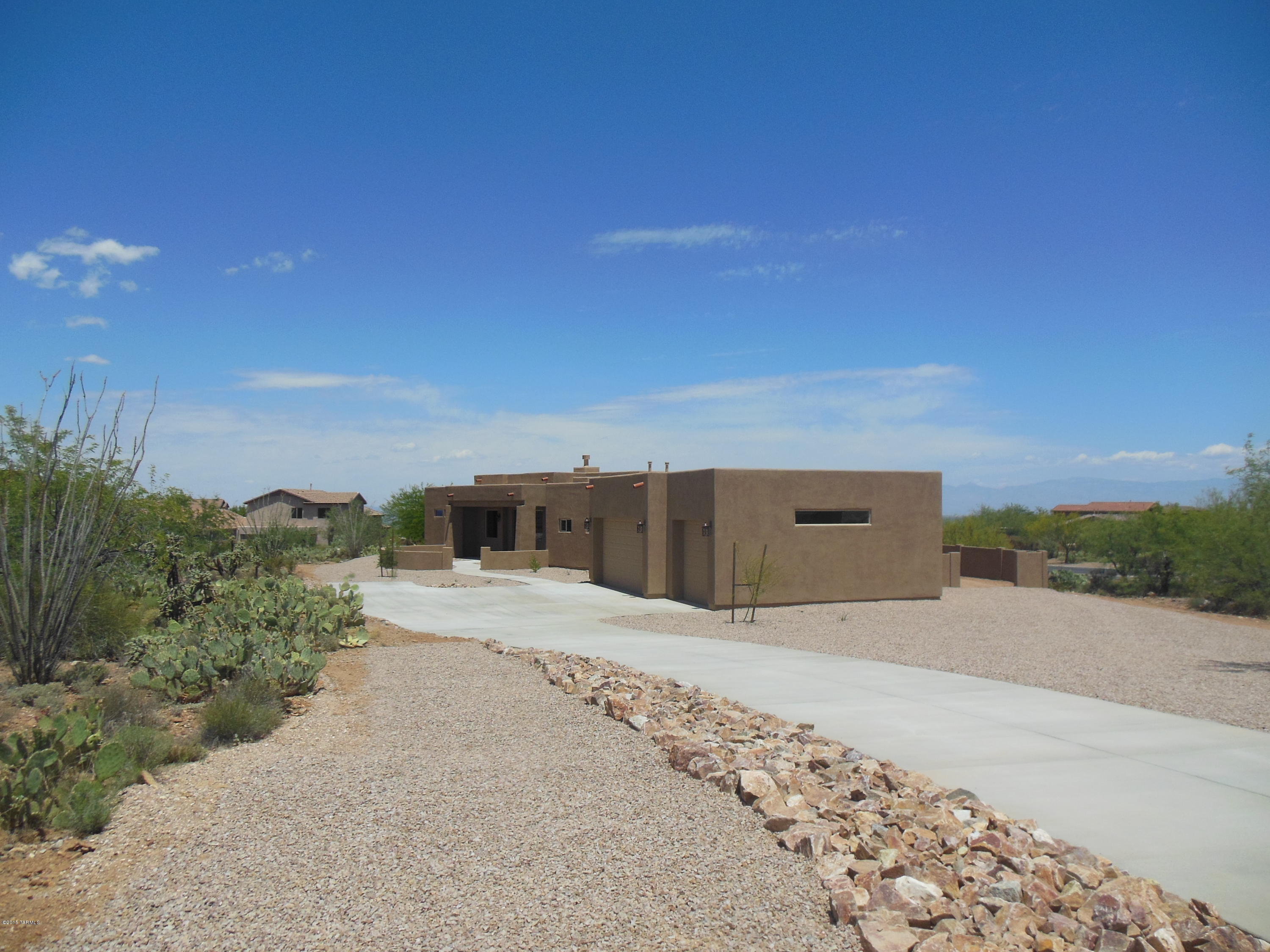 Move-in ready, one of a kind Sombra Homes southwest style Model 2360, located in a gated subdivision with outstanding views of the four surrounding Tucson area mountain ranges. Situated on an approximate 3/4 acre lot, this home includes a Great Room, Dining Area, Split Floor Plan, 3 bedrooms, 2 1/2 Baths, 3 Car Garage, and a large covered patio. Quality standard features include granite kitchen countertops, Oakcraft cabinets, GE appliance package, ceramic tile, dual-pane & Low E windows, 8' garage doors, 8' primary interior doors, security system pre-wire, and a gas fireplace. Please contact either Mike Blake or Lewis Mitchell for an outline of the many upgrades that are also included in this quality Sombra Home.