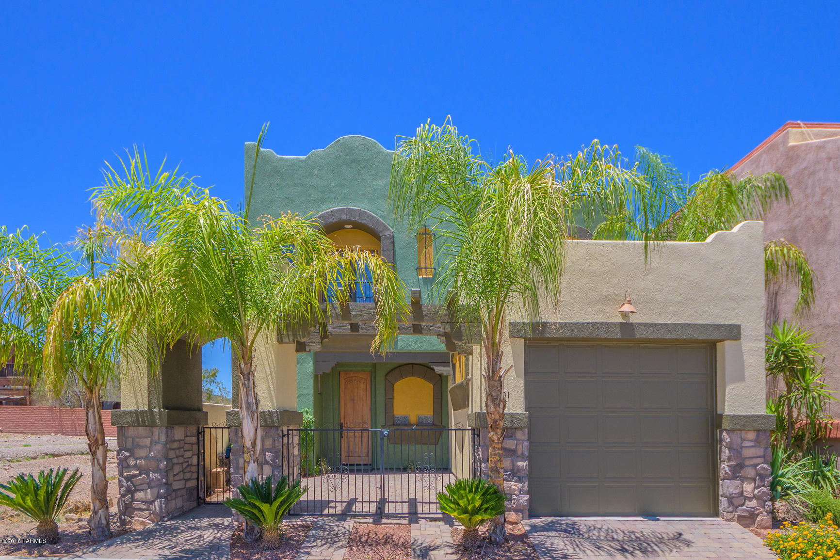 RANGE PRICED: Seller to accept or counter offers between $299,000 & $349,000. This incredible home has dramatic touches like Decorative 8' front door, exterior 1 lite french doors, alder interior doors, 10' high ceilings, 8' high windows, Decorative cabinets W/ 42'' high uppers, arched niches, sun decks/porches outside each bedroom, private walled front & back courtyards, built-in Exterior BBQ, upgraded floor coverings, exterior fountains, finished garage. Great city/mountain views. Located in a private 14 lot walled community with community pool, spa & BBQ area. Within walking distance to medical, shopping, Pima Community College and easy, close access to new modern street car, Downtown, and U of A. Truly unique, compares to nothing else in the area. A real gem and must see.