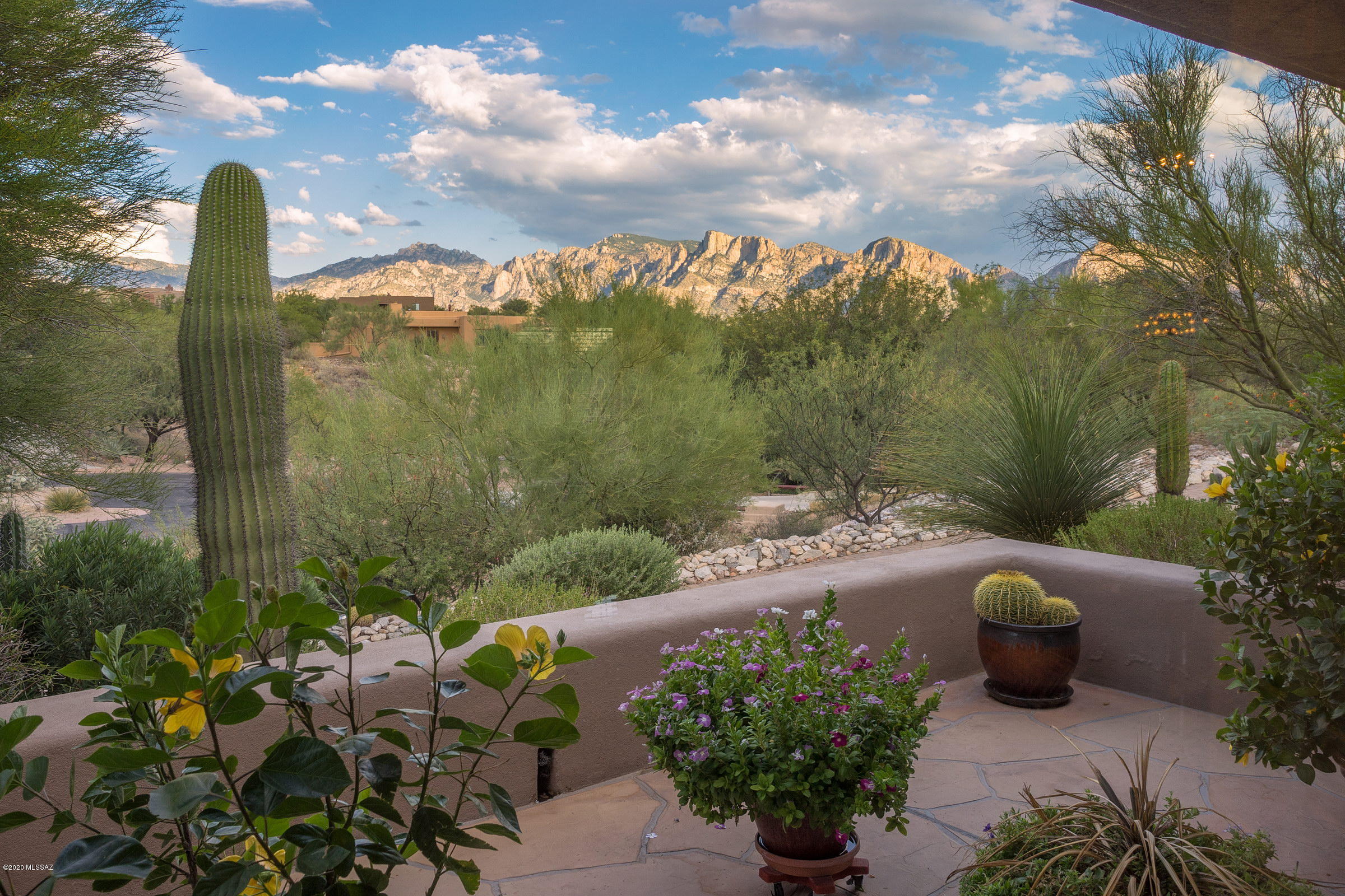 Designed by the renowned David Tyson, this 3 bedroom, 2 bath located in gated Coyote Ridge with Catalina Mountain views is perfect for a winter or year-round residence. Situated on an ultra-private lot multiple patios offer seamless indoor/ outdoor living. Stylish taupe Moreno Saltillo, gorgeous hardwood and rich slate in this home pair well with the gorgeous Sonoran vistas visible through the floor to ceiling oak encased windows throughout. Open kitchen with granite counters and backsplash is well equipped with a Sub-Zero refrigerator, and new Bosch appliances, including gas range. Master suite is luxurious with fireplace, private patio and sumptuous bath. Other features in this outstanding property include recessed art lighting, electric power shades, mini-split in garage and more.