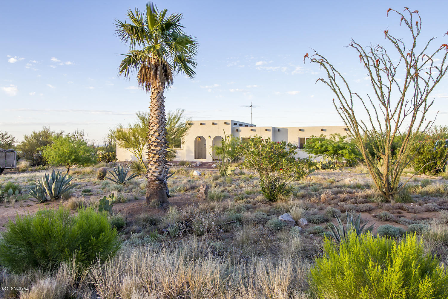 Spectacular Diamond Bell Ranch Sante Fe Home! Country lifestyle just minutes from town on acre of Sonoran desert! Circular driveway and incredible mountain views!  2137 sq ft (1737 sq ft plus additional 400 sqft not included in assessors.) Greatroom with vaulted ceilings and wood beams! Arches across the central half of the house.  Big kitchen with lots of vintage cabinetry and breakfast bar. Spacious guest-wing with separate entrances! Lovely diningroom.  Private master suite with walk in closet. 2017 remodel upgrades include new double pane windows throughout, 2 patio sliders, new solid core front door, 2 new AC/ furnace split systems, new hot water heater, new carpet & flooring throughout, exterior paint, exterior faux vega beams, upgraded electric panel and 10 roof coolcoat warranty. New toilets and new electrical receptacles throughout home. Spacious chain link fenced area in backyard and shed! Home is priced to sell being sold As Is.