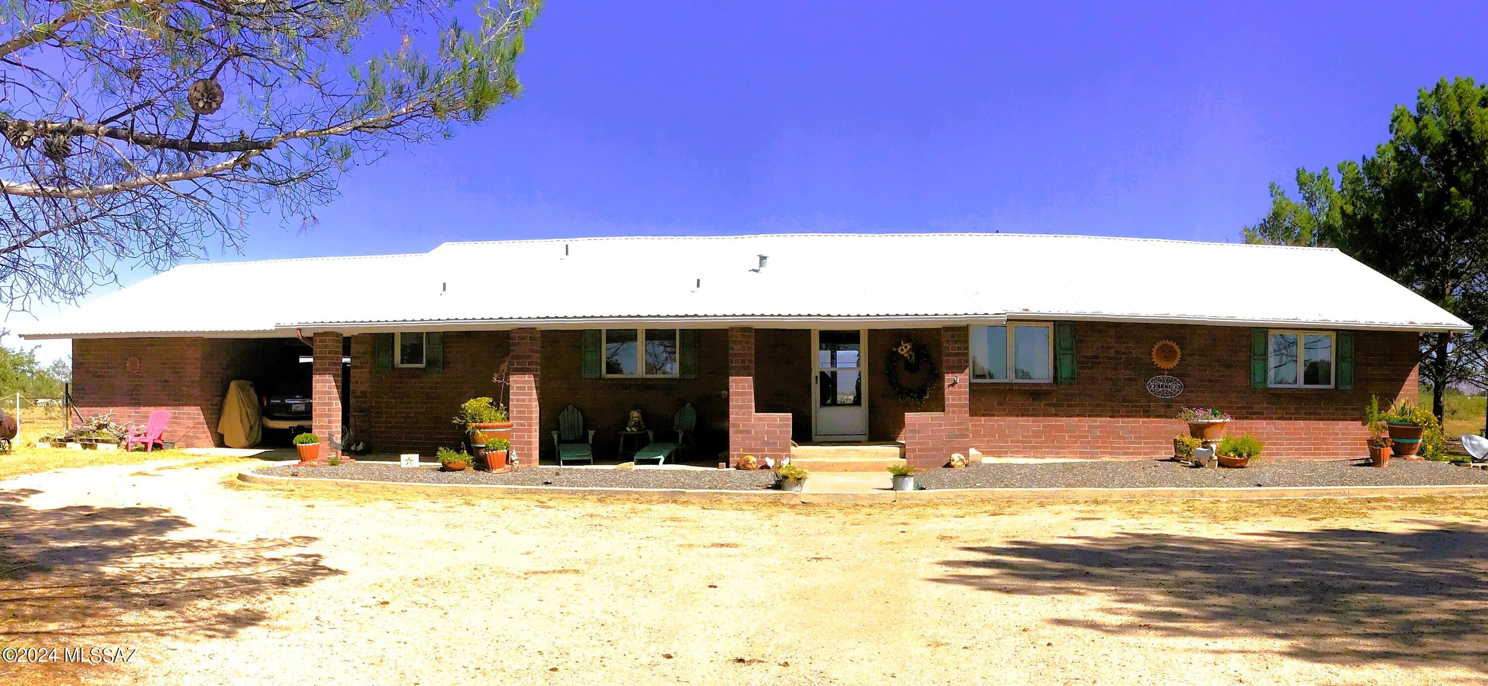 60 acres total. 40 acres has a 2196' 3-bedroom, 3-bathroom brick home with an attached 864' brick carport. There is a 2496' barn with stalls, kennels, workshop, common area, & an attached fenced arena & corral. The house has a large mud room with lots of wall storage cabinets, a laundry room area with sink that stay & a 3/4 bathroom. Inside is open concept with a beautiful kitchen that has lots of cabinets with unique organizational storage. The large dining room has a sliding glass door to the covered back patio & fenced-in back yard. The Living room has a wood burning stove and large picture window with custom curtains that stay. Bedrooms & bathrooms are very roomy. Storage everywhere throughout home. The attached 20 acres is also fenced & ready for your imagination.