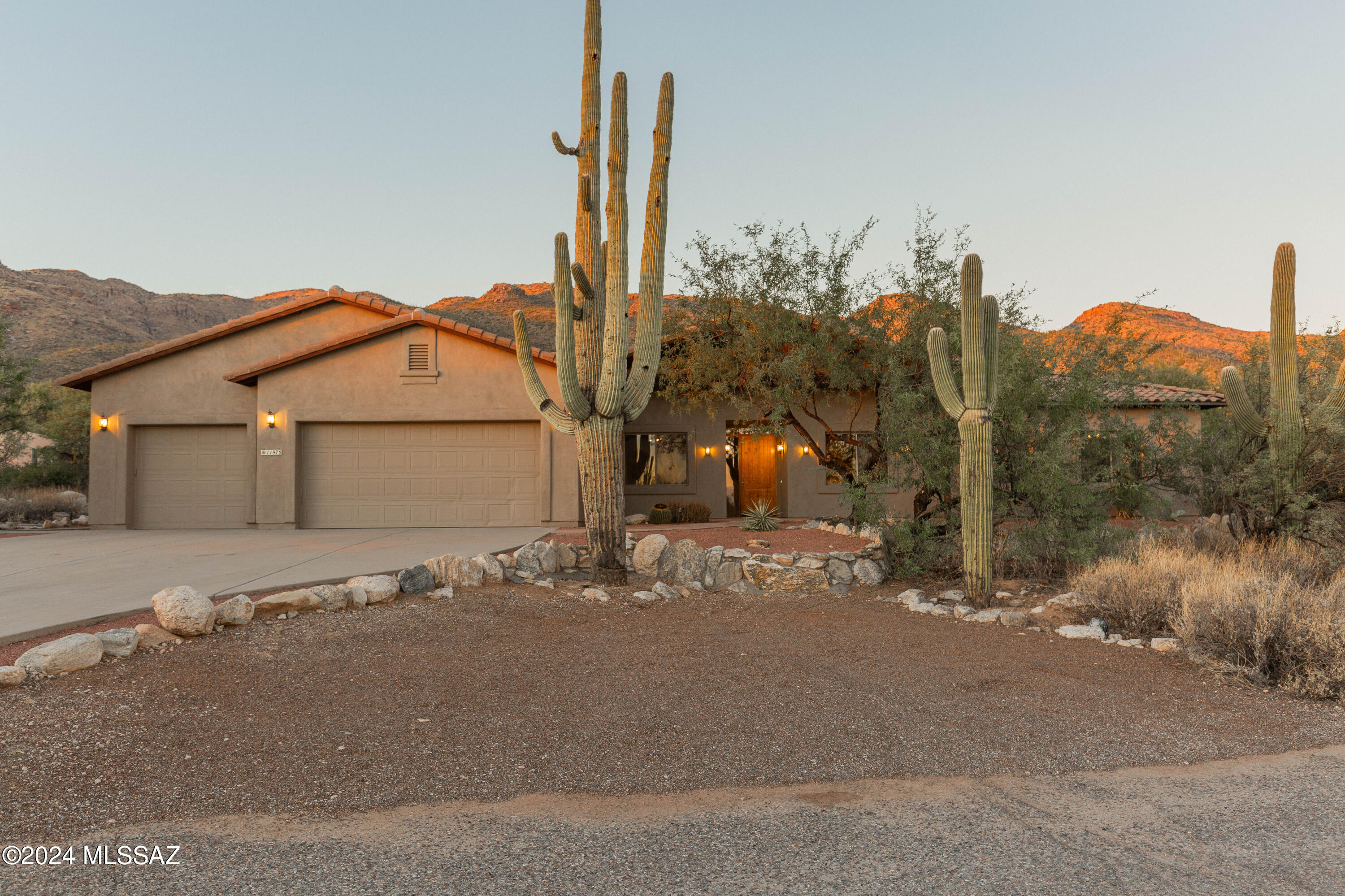 Welcome to your serene oasis! This delightful ranch-style home is perfectly situated at the base of the breathtaking Catalina Mountains, offering panoramic vistas views and a tranquil atmosphere. This home is situated on 3.3 acres in a peaceful & private custom home neighborhood, surrounded by acres of natural beauty and tranquility of the desert while being just minutes away from outdoor adventures.
Upon entry you are invited to an open-concept layout with large windows that bring in natural light and showcase mountain views. Exposed soaring wood beamed ceilings add dramatic architectural detail that adds warmth and character to the spacious living areas. Spacious kitchen features granite counter tops, oak cabinets, gas stove, stainless steel appliances, ample storage.... and plenty of space for entertaining. Upon entry sits another bonus room with beautiful glass french doors that would be perfect for an office or library. Primary suite features an en-suite bathroom with dual vanities, a soaking tub, walk-in closet and a fireplace.. perfect for warm ambiance while enjoying more mountain views. Additional four well-appointed bedrooms provide ample space for family and guests and bonus room is ideal for a home gym, playroom, media room,or in-law suite complete with 4th bedroom attached and bath. Finally, this stunning backyard is an outdoor paradise! This expansive outdoor space features a sparkling pool with spa nestled under the captivating views of the mountains, expansive wood beamed porch, pool bathroom/powder-room, outdoor stone fireplace, soaring saguaros and lush surrounding desert...perfect for relaxation and gatherings. No HOA allows for RV parking, extra acreage allows for expansion. Brand new tile Roof Installed October 24, providing durability and style. And freshly painted full exterior and full interior paint, giving the home a refreshed look. Don't miss your chance to own this incredible Tucson ranch home, where luxury meets nature!