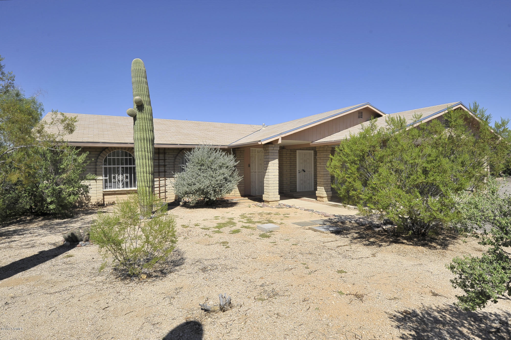 Located on approx half acre lot/separate storage garage in rear, Low care yard, rear covered patio, south of home fruit trees, new gas self clean stove and micro.  Interior completely repainted.   Large pantry area with lots of storage, separate laundry room.  Master bedroom is large with walk in closet.  Arizona Room/Family room off the livingroom with separate storage room also.  Fireplace is in the Arizona Room/Family room which is all tile.   Near Medical facilities at Orange Grove and La Cholla.    Easy access to I 10    Kitchen has small built in table with chairs included.   Non working spa; as is and will not be fixed.Ask about P#3103M