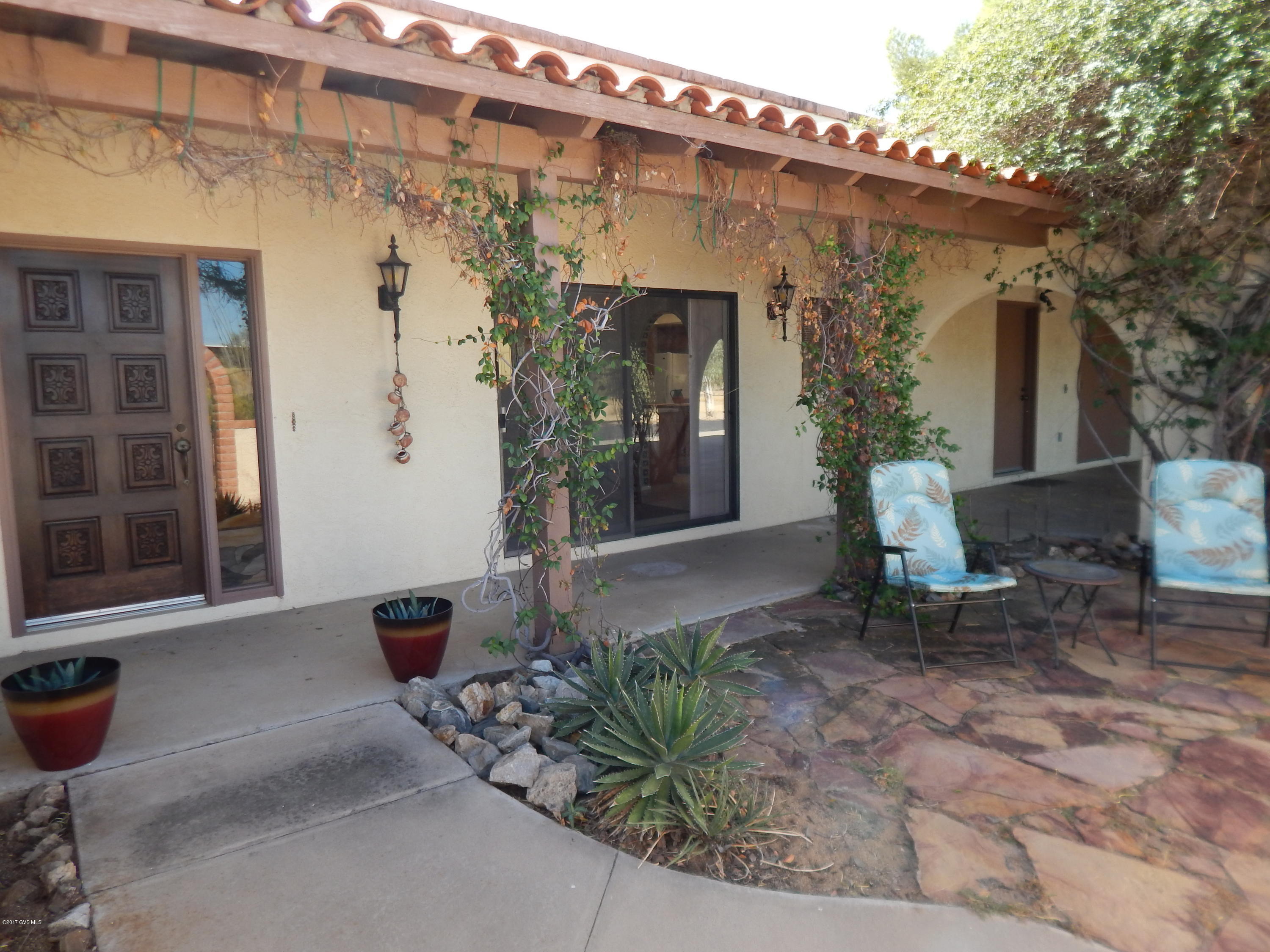 Your own Hacienda to welcome you home. One Owner home with no HOA, see through fireplaces, tiled arches, tiled window sills, AZ room, Coivered patio and front courtyard. Circular driveway on an Acre plus with Oversized 2 car garage and 2 car carport!
