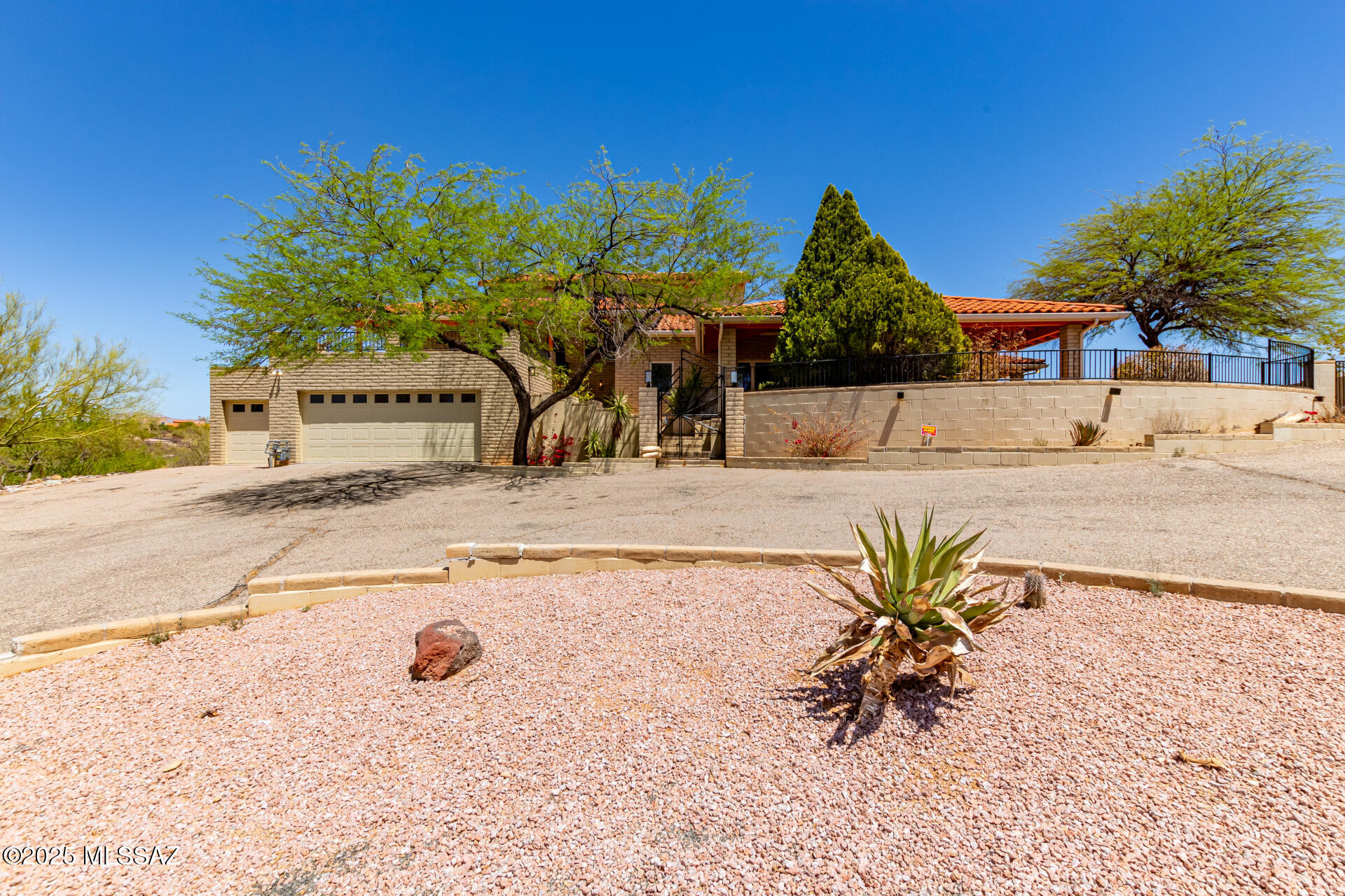 PRICED TO SELL! Nestled on 3.7 acres of land with breathtaking Mountain Views and circular driveway. Private gated front entry, soaring ceilings, brick accent walls, large picture window, plant shelves, soothing palette, built-in medial wall, ceiling fans, French doors to patio, and unique brick paver floors. This is a very special style home with creative angles and designer touches. 5 bedrooms, 3 baths, additional flex rooms ideal for office, kids retreat, craft room, den, and more! Updated kitchen, breakfast bar, SS appliances, and wood cabinets. Plush carpet in all the right places, loft area with endless possibilities, skylight, and upgraded lighting. Vaulted ceiling in master retreat with beautiful tile floor, and private en suite. Huge deck with incredible city and mountain views! Lower level offers laundry room with utility sink, generous size bedrooms, and ample closets/storage. Enjoy the sparkling fenced pool, spa, 2 covered patio's, and exterior fireplace. Don't miss oversized 3 car garage with plenty of storage. This is a one of a kind gem in the desert!