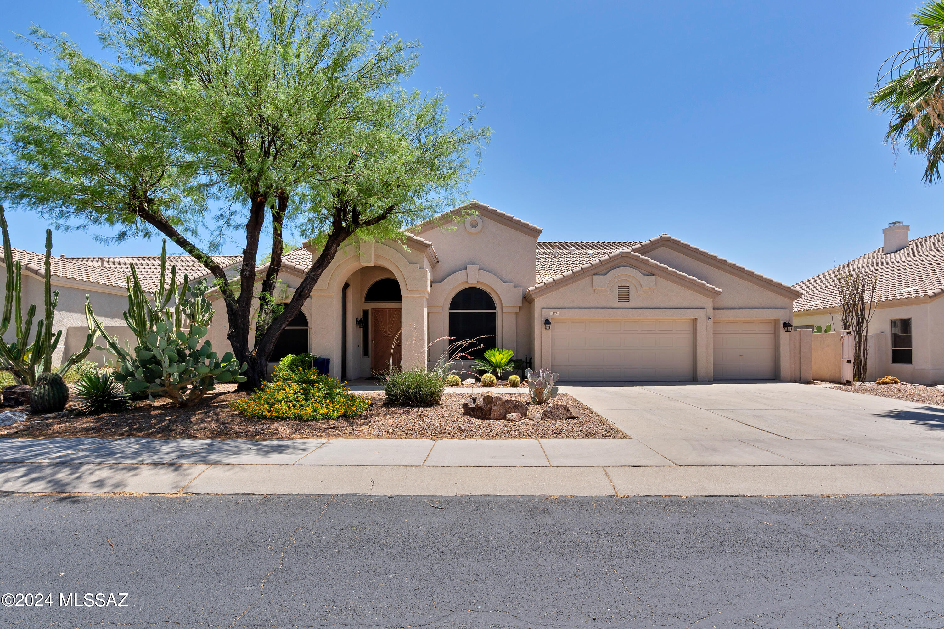 Modern Luxury Living in the desirable Rancho Vistoso community! This updated 4 bedroom 2.5 bath home includes a remodeled gourmet kitchen with beautiful granite countertops, large island, stainless steel appliances including built-in ovens/microwave, soaring ceilings, a huge master suite, 3 car garage, gorgeous engineer wood throughout the home, a fireplace in the living room & backyard, and mountain views! Relax as you step up into the luxurious jetted tub or as you step out into the Saltwater pool + Hot Tub. Entertainers' backyard features a covered patio, built-in BBQ, outdoor fireplace, and sparkling pool. Enjoy all that the community has to offer. Close to Hohokam Park, Basketball Courts, dog park and much more.