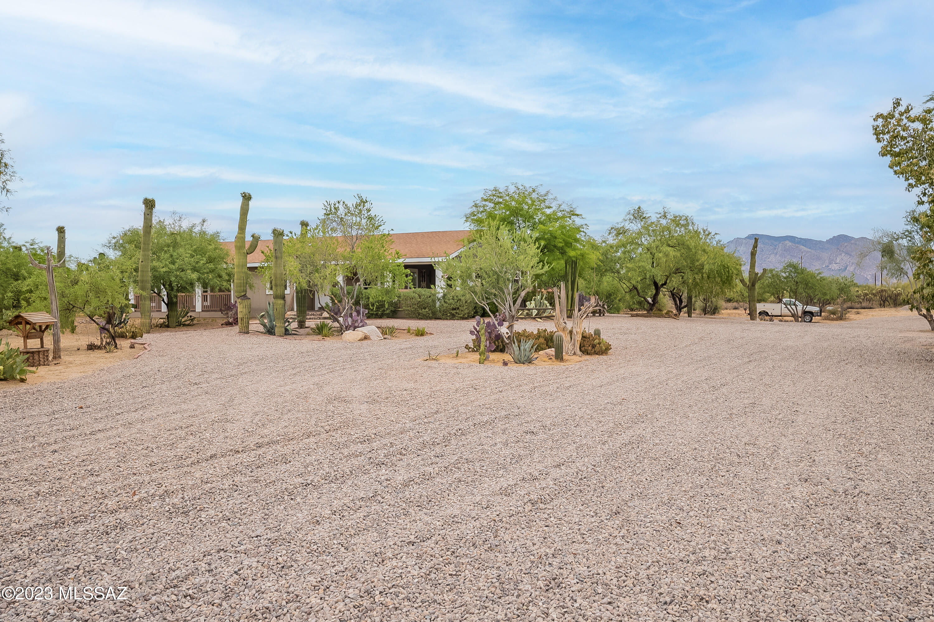 Rare find! 5 Gorgeous peaceful acres in town. Spacious 4 bedroom 2 full bath home with over 3100 Sqft of living space and over 2000 sqft of porches and patios. New roof and hot water heater. Outdoor Kitchen, Inground Pool, Pool house with bathroom including a shower, Storage shed and work shop / tack room with swamp cooler. Lit Roping Arena with Calf chute, Alley, Turn outs and four 20'x40'. Pens with shade structures. Can ride to state land from the house! Full RV hook up and per the county another home or guest house is allowed on the property. Plenty of room to spread out and enjoy. All of this just minutes from I-10 and stores.