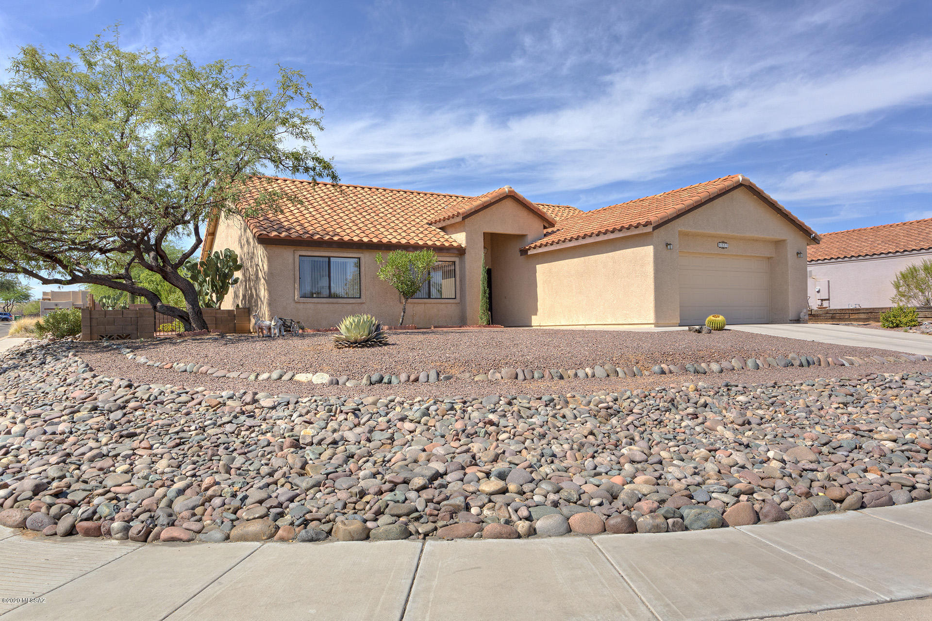 Charming 3 bedroom, 2 bath  home situation on a large corner lot with beautiful Santa Rita Mountain views from front yard. You will enjoy beautiful sunrises. Tile roof.  This gently used home with no carpet and a split floor plan will delight you.  Large completely fenced backyard yard with  a  patio stretching the full length of the home.  Home backs to a vacant lot for extra privacy.  Nice size kitchen/dining area with large breakfast bar.  NO HOA OR GVR, but GVR is available.  Owner is an artist and most all paintings are for sale. 
HOME WARRANTY OFFERED!!!