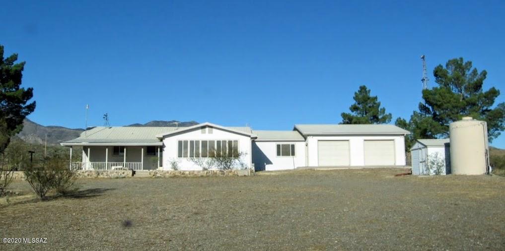 40 acre HORSE PROPERTY situated at the base of the Dos Cabeza's mountain Range. Graced with a combination of rustic western charm and spectacular mountain vistas. This property is fully fenced, cross fenced and equipped with a ROUND PEN, horse barn, hay storage, dog kennels, extra storage facilities, incubation rooms for raising Quail as well as chicken/quail huts, FULLY ENCLOSED with chicken wire. This tucked away gem has a wonderful four bedroom home with a MULTI CAR GARAGE, updated kitchen, washer and dryer, plus a naturally lit Arizona room looking over the valley giving you a front row seat to the spectacular Arizona sunsets. This parcel is secluded with a PRIVATE WELL, giving you the feeling of off grid living, but the luxury of city electric! Grab your saddle and come check it out!