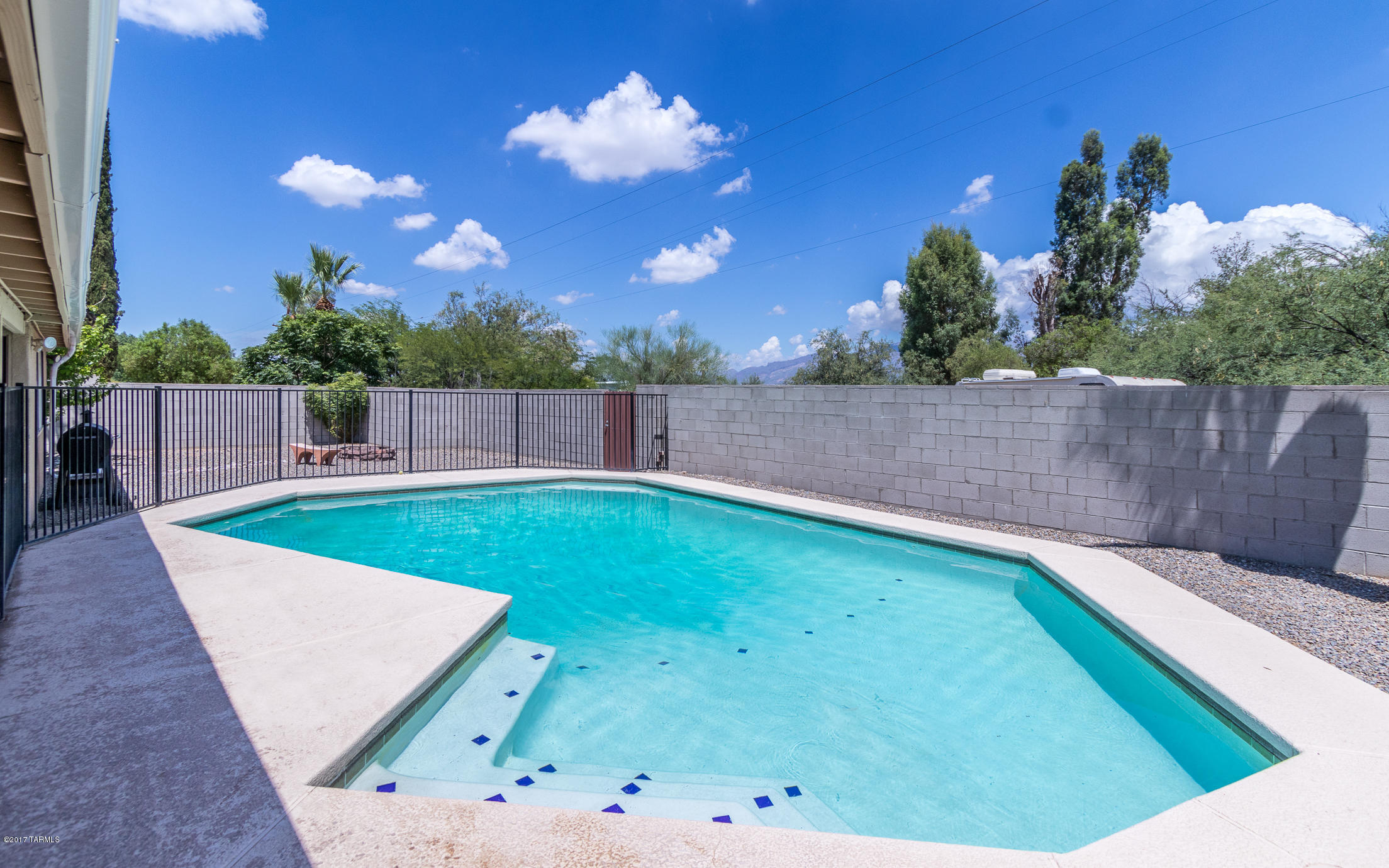 Charming four bedroom home in the 
Hidden Hills East neighborhood. Spacious kitchen has dark wood cabinets,tiled counter tops and stainless steel appliances. A SEER 16.0 AC unit was installed in 2014 and a new water heater installed in 2016. Family room has a cozy brick fireplace. Backyard features a covered patio with TV, enclosed eight foot deep pool, low care landscaping and a fire pit.