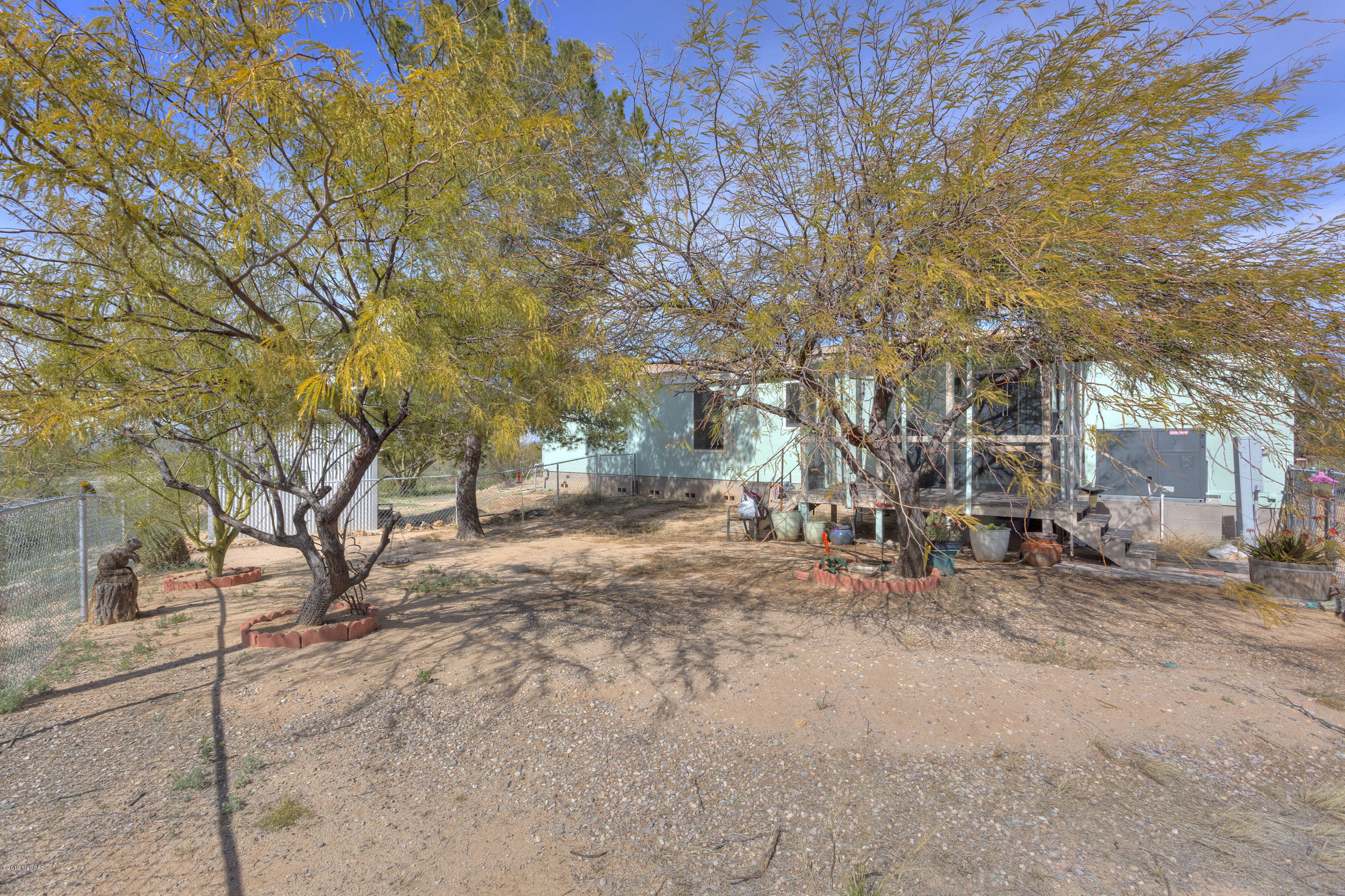 Beautiful 2010 3BD/2BA affixed mfr home with a pristine kitchen, roomy living room, walk-in closets, gorgeous mountain & night views of the city lights and the peaceful quiet of being off the beaten path. Enjoy the wide-open acreage, fenced yard, above ground pool & spa or sit on the well cared for covered patio. Shed at rear of home for extra storage. 4 car garage/workshop is an approx 1600 sq ft mechanic, engineer, or woodworkers' dream with plumbing access easy to set up to the existing bathroom within.  A 50 amp RV hook up with sewer and ample space for any size RV are also found on the property. 2 septic tanks. Very easy access from asphalt road, only about 500 feet of gravel road to driveway.
