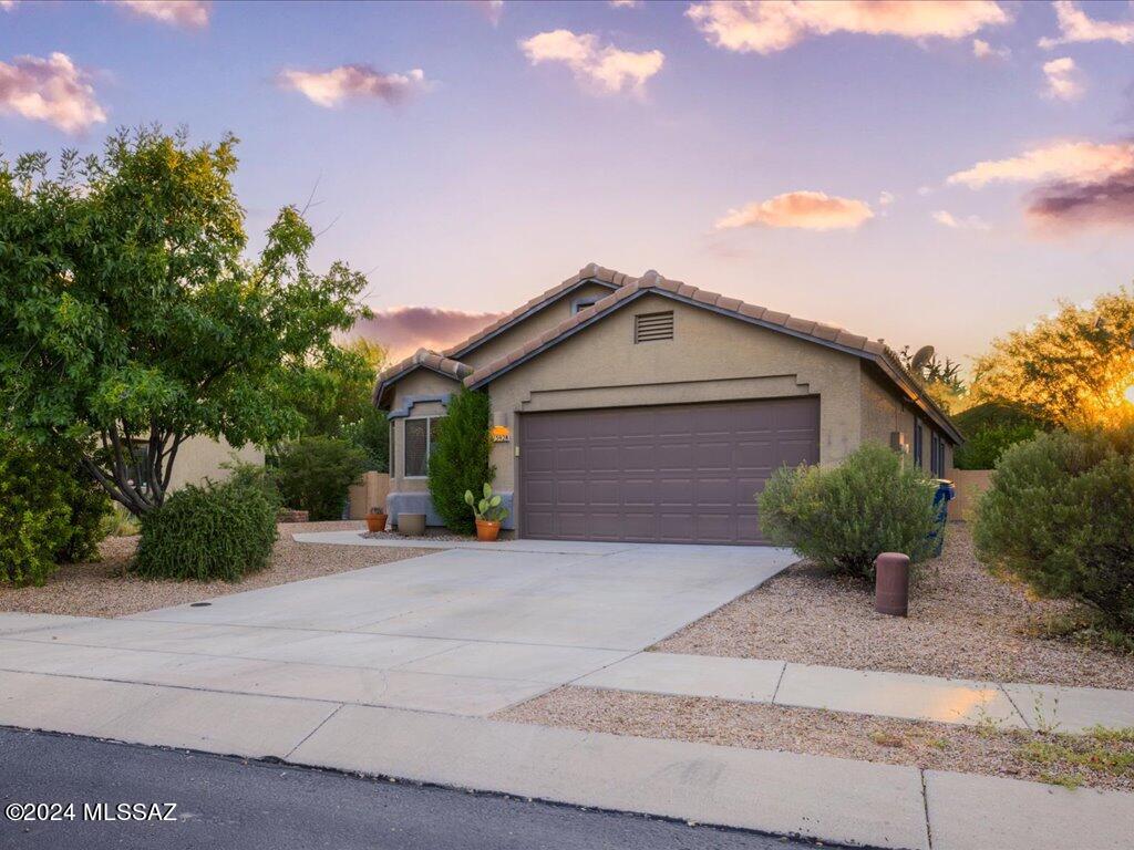 This beautifully maintained 3-bedroom home features an open floor plan and vaulted ceilings, close by the amenities of Rancho Sahuarita. The spacious kitchen is complete with granite countertops, a center island with a breakfast bar, and a dining area. The primary bedroom offers plush carpeting, a private bathroom with a soaking tub, and a walk-in closet. Enjoy the versatile living room which includes an extra room, perfect for an office, game room, or additional living space. The laundry room and garage include built-in cabinets for extra storage. The backyard is a peaceful retreat with irrigated landscaping, citrus trees, a large covered patio, extended pavers, and a hot tub! Schedule your showing today!