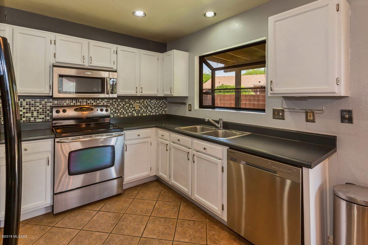 Beautiful 2 bedroom/ 2 bath home with open floor plan! Kitchen boasts newer stainless-steel appliances with dishwasher less than a year old and custom backsplash. Master shower updated with gorgeous tile! Guest bathroom has upgraded vanity. Newer water heater, smoke detectors in every room, garage door opener, and garbage disposal. Entertain family and friends in your low care backyard that backs up to partial common area. Located in the desirable Shannon Club Neighborhood across the street from the Omni Tucson National Golf Course and Resort. American Home Shield Home Warranty included.