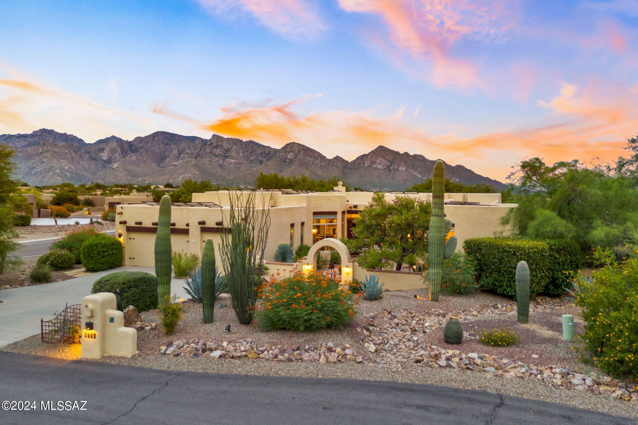 Prepare to be amazed by the beauty of this Vistoso Estates Modern Santa Fe, nestled amongst the breathtaking Pushridge Mountains. The ever-changing hues of these stunning mountains create a mesmerizing backdrop that will leave you in awe throughout the day. A soothing fountain and flagstone patio greet you as you enter the gated courtyard.  Get ready to be wowed by this home's incredible features.

Experience the luxury of owned solar, which keeps electric bills as low as $25 per month! This home underwent a complete chef's kitchen remodel in 2017, boasting a huge island, granite counters, slate appliances, double ovens/convection, gas cooktop, soft-close cabinets, pullouts, prep sink, and a wine refrigerator. The great room welcomes you with a stunning custom stacked stone gas fireplace, while the formal dining area and family room equipped with a Big Screen TV and surround sound system offer perfect spaces for entertaining.

That's not all! This home also includes guest quarters with a bedroom, kitchenette, and a full bath, plus two additional large bedrooms sharing a full bath. Enjoy tranquil moments in the sanctuary atrium with a soothing fountain, easily accessible from the owner's suite and family room/great room. The owner's suite features clerestory windows, sliding doors to the pool & spa, and a completely remodeled ensuite bath with a large walk-in shower and an elongated soaking tub.

As you step outside, you will be captivated by the stunning backyard offering panoramic mountain and sunset views, a putting green, pebble tec pool and spa with a waterfall feature, and an extended patio with a cozy firepit, perfect for Fall and Winter nights. 

In 2017, all tile floors were replaced, two new HVACs, Water Heater, the front and back yards were relandscaped, and a new water feature and pool equipment were installed.  The Viga Beams were replaced in 2018/2019.  In 2024 the roof was inspected and recoated.  

With all these incredible features, this home is an absolute Arizona gem waiting to be discovered!  Minutes from shopping, dining, golf, tennis, pickleball, dog park, Oro Valley Hospital, hiking, biking, and the infamous Hohokam Park, Oro Valley Community Center, Library, RiverFront Park, and the Steam Pump Farmer's Market; Oro Valley has so much to offer.