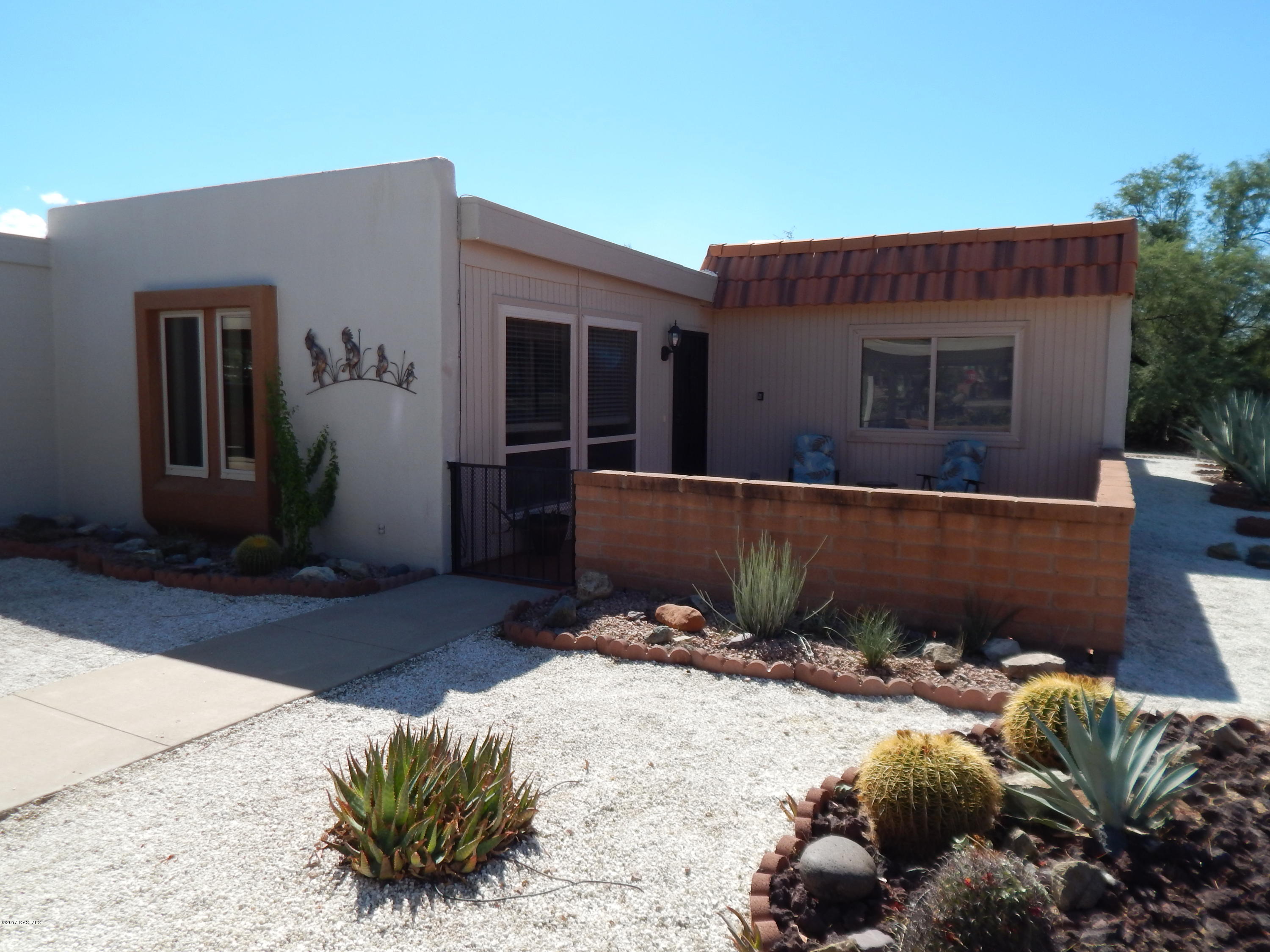 End Unit tucked back on a corner lot with plenty of privacy. With this double carport, front and back patios and AZ Room, you will be entertaining in style! Newly updated with new paint, new lighting, 20'' tile and new carpet in bedrooms and New hot water heater. The large Pantry closet and washer & dryer closet is tucked away off the kitchen with Corian counters. Easy care landscaping and a cute mountain view from the back yard. Dual pane vinyl windows help save costs. Easy show.