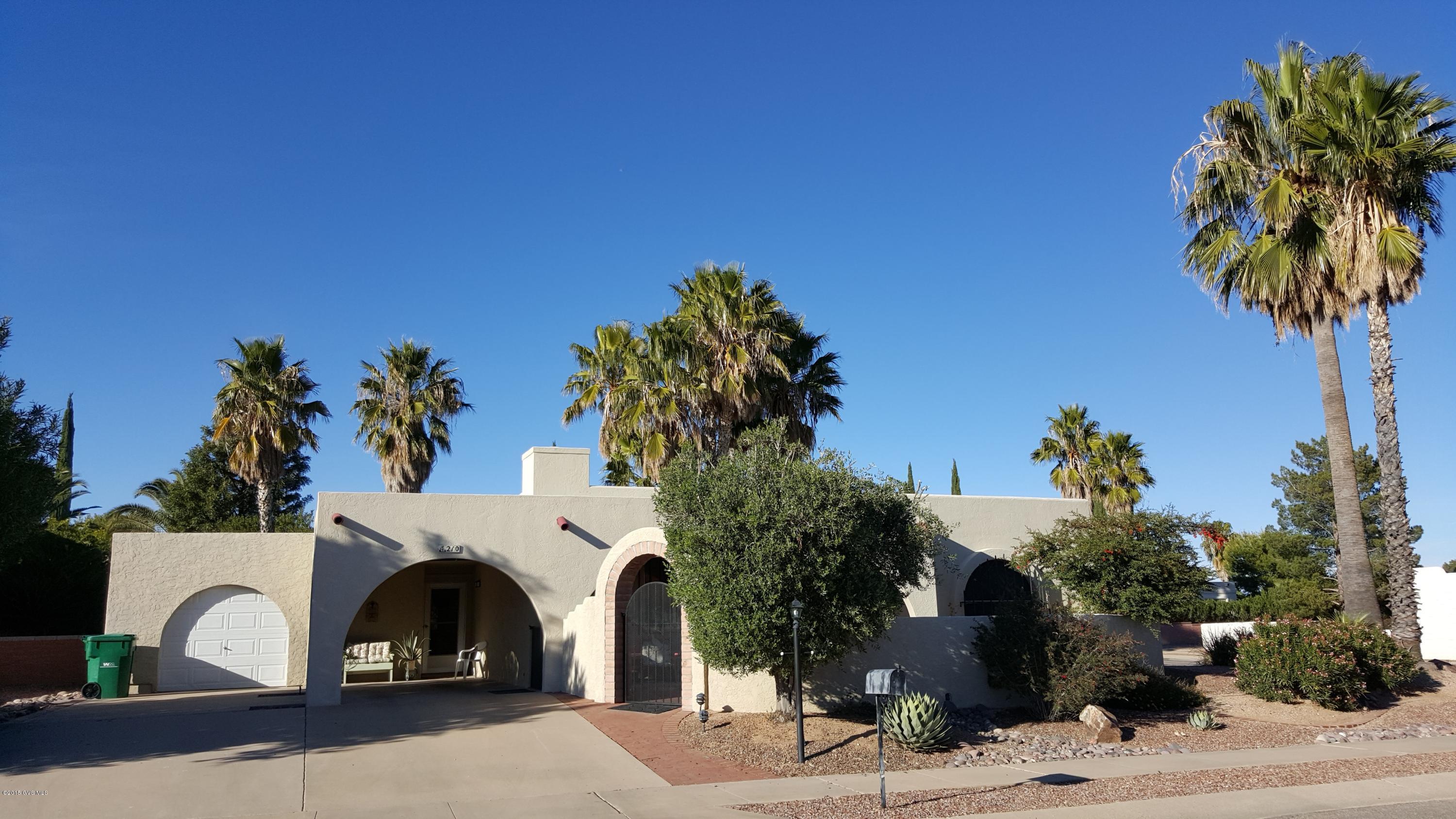 Exterior Arches & a fabulous front courtyard welcome you to this 1,433 sq. ft. Southwest architecture home on a Large Corner lot w/abundant mature Fruit & Palm Trees surrounding various backyard brick patio seating areas from which to enjoy Sunrises & Sunsets + entertain guests. The open concept living room features a gas log beehive fireplace next to the dining room + adjoining Arizona Rm. Large kitchen with a window over the double sink + pantry. Separate Laundry inc. W/D. Skylights. Ceiling fans + Central A/C. Gas Furnace & Water Heater. Back patio access off the Master Bedroom w/3-pc en suite Master Bath & a walk-in closet. Guest bedroom with full bath across the hall. Ample parking options inc. a golf cart garage + carport + extended driveway. The Active Adult lifestyle W/GVR awaits!
