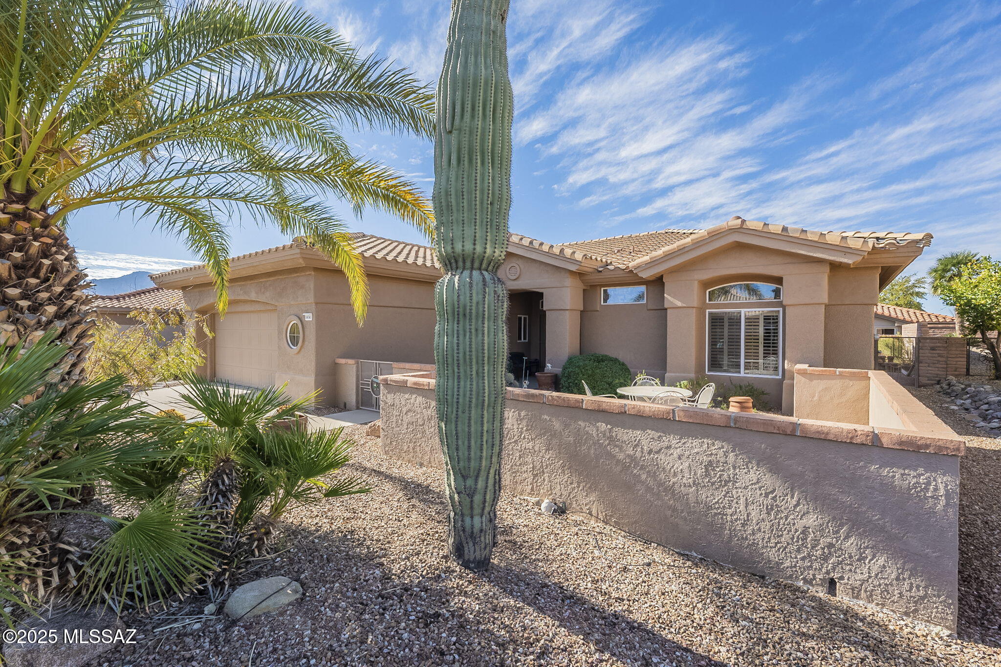 Welcome home! This Sunrise Model offers 1,818 sq ft with 2 bedrooms and   2 baths, featuring a spacious, inviting layout filled with natural light from large windows. The open kitchen seamlessly connects to the AZ room making it perfect for entertaining. The great room enhances indoor-outdoor living with easy patio access. The primary suite is spacious, offering mountain views, a large walk-in closet, and a private bath.  The guest bedroom includes built-ins and a Murphy bed, making it a versatile multi-purpose space. Enjoy your morning coffee in the front courtyard as the sun rises over the Catalina Mountains. Situated in an active adult community, you'll have access to incredible amenities, making this home an ideal place to relax and enjoy life. HVAC 2013, Roof Underlayment 2019