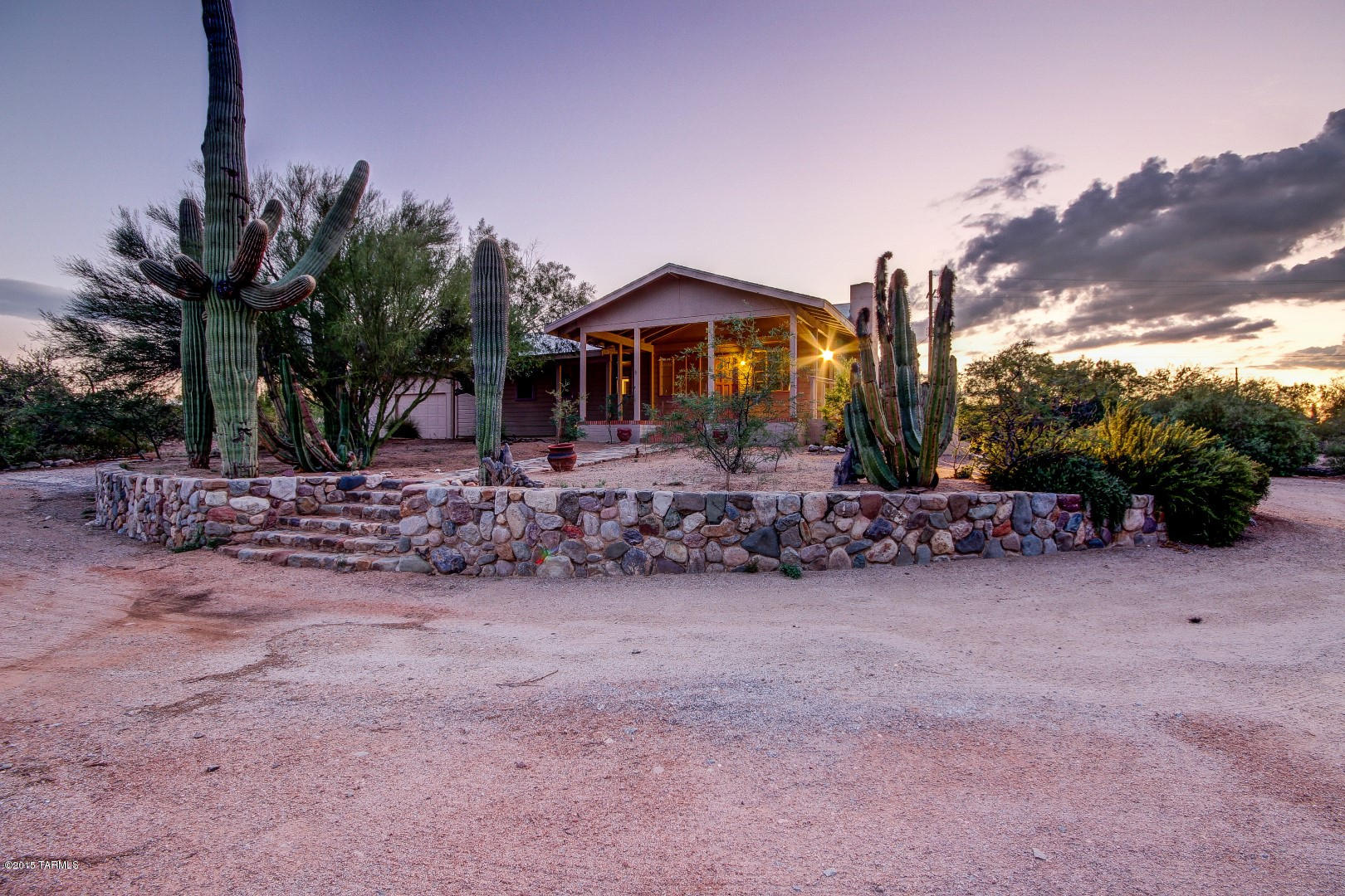 Gorgeous property with the spectacular mountain views Tucson is known for. Totally flat usable lot. A true horseman’s property: 6 pens (most w/shade), turn-out, flat fenced riding area, several cross ties and wash racks. Modern tack/feed room, as well as a rustic tack shed which could be used as a chicken coop or? Load up the ponies for a 5 minute drive to miles and miles of trails. This coveted subdivision at the base of the Rincon Mountains has no HOA and many original owners; these lots are rarely available! Majestic saguaros and cactus gardens accentuate the stunning scenery surrounding this property. The house needs quite a bit of work, mostly cosmetic, but could be used as a guest house when you build your dream home. Don’t let your horse owners miss this! Sold As-Is
