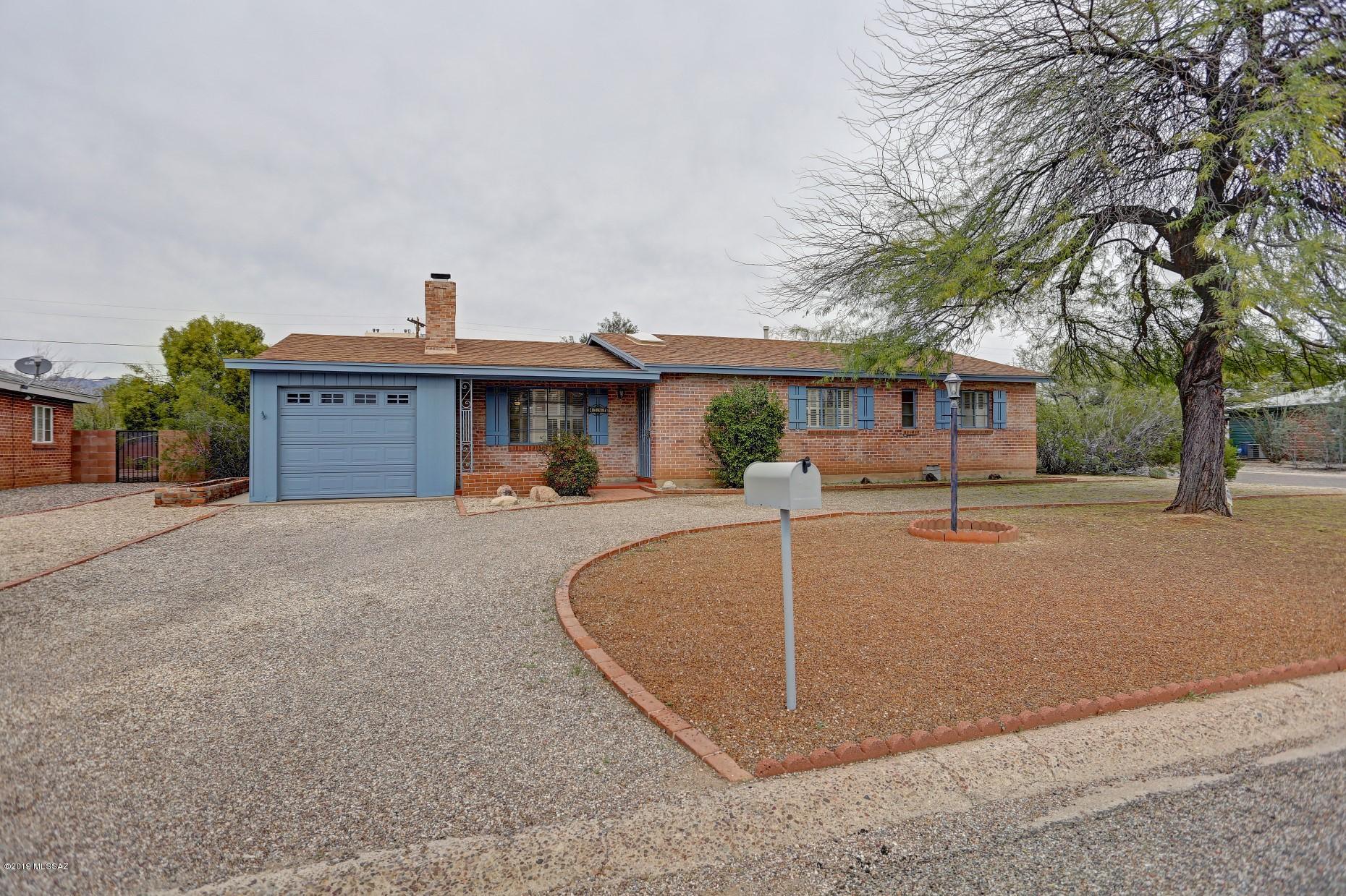 Fantastic charming centrally located home with guest house and Arizona room invites relaxation and is move in ready.  Settle in a comfy chair with a cup of coffee, the paper or a book, listen to the sounds of nature or watch children play on the paver patio under the tree while enjoying the quiet.   Plenty of character in this clean home with built in shelving and cactus motif fireplace surround. French doors open to an inviting Arizona room perfect for al fresco dining, or  curling up to read a book.  Guesthouse is living-sleeping area with small kitchen and 3/4 bath, or use it as a separate office space, large craft area, or big workshop.  Close to  shopping and a bus line, this home is located in a quiet serene neighborhood with privacy.  2 year old roof, newer AC, stove, and more!