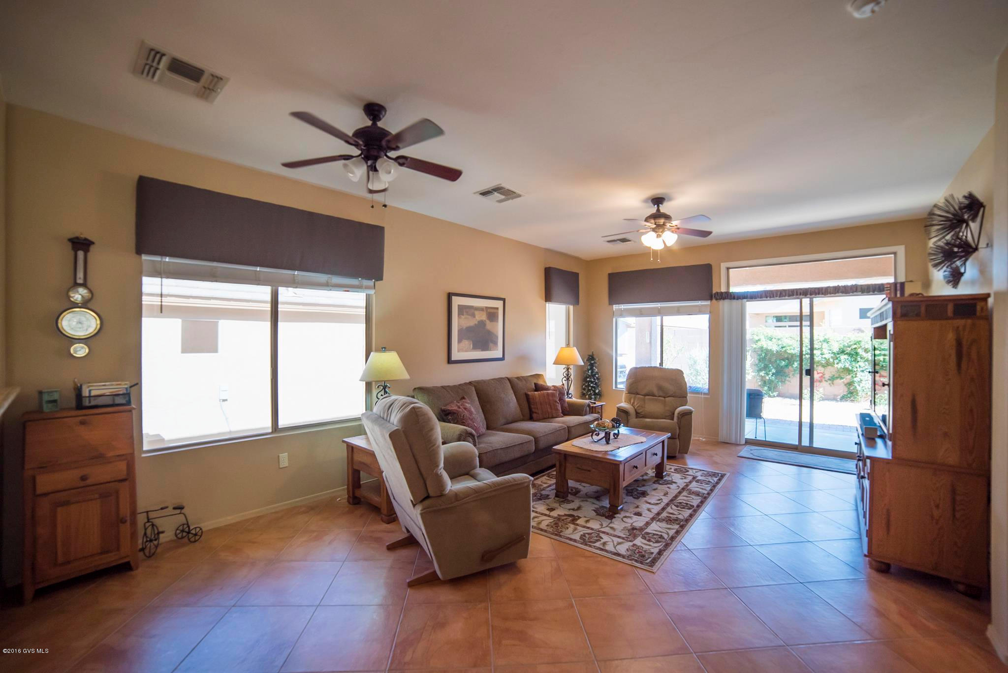 Located in the gated community of Sonata, this home has a contemporary design with low maintenance landscaping featuring numerous cacti and river rock. You'll enter into a conventional living room decorated with natural desert colors brought to life by two big windows. Continue on to the great room with beautiful tile flooring set on the diagonal and large windows filling the room with natural light. The kitchen offers recessed lighting to bring out the rich wood grain of the cabinetry along with beautiful solid granite countertops, backsplash and angled serving bar. Your will find easy care wood floors throughout the rest of this immaculate home. It features a large master bedroom suite with dual sinks, storage closet and oversized shower enclosure. Relax and enjoy special times on  your covered back patio with its easy care yard. Convenient location in the heart of Green Valley near shopping and recreation centers.