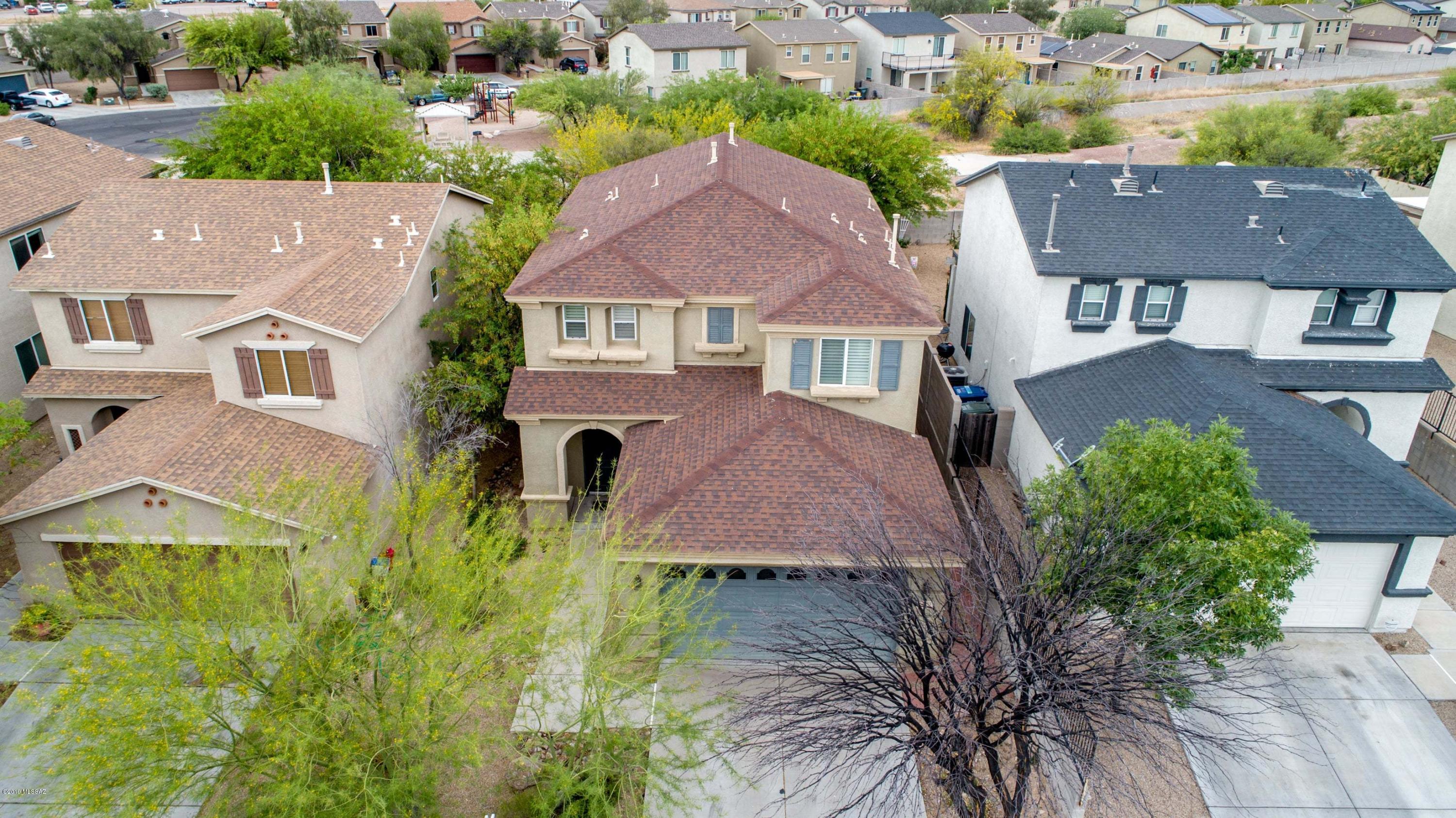 Enjoy this beautiful two story former model home in a quiet community! Wood and tile floors throughout first level, with beautiful crown molded cabinets in the spacious kitchen, and recessed lighting galore. Fully landscaped front and back yard and no neighbors behind you offers great curb appeal and a tranquil backyard retreat. 4 spacious bedrooms upstairs including
master suite, loft area, full guest bathroom and newly replaced carpet. Easy access to freeway travel, shopping, downtown, and U of A. Come view it today! Won't last long!