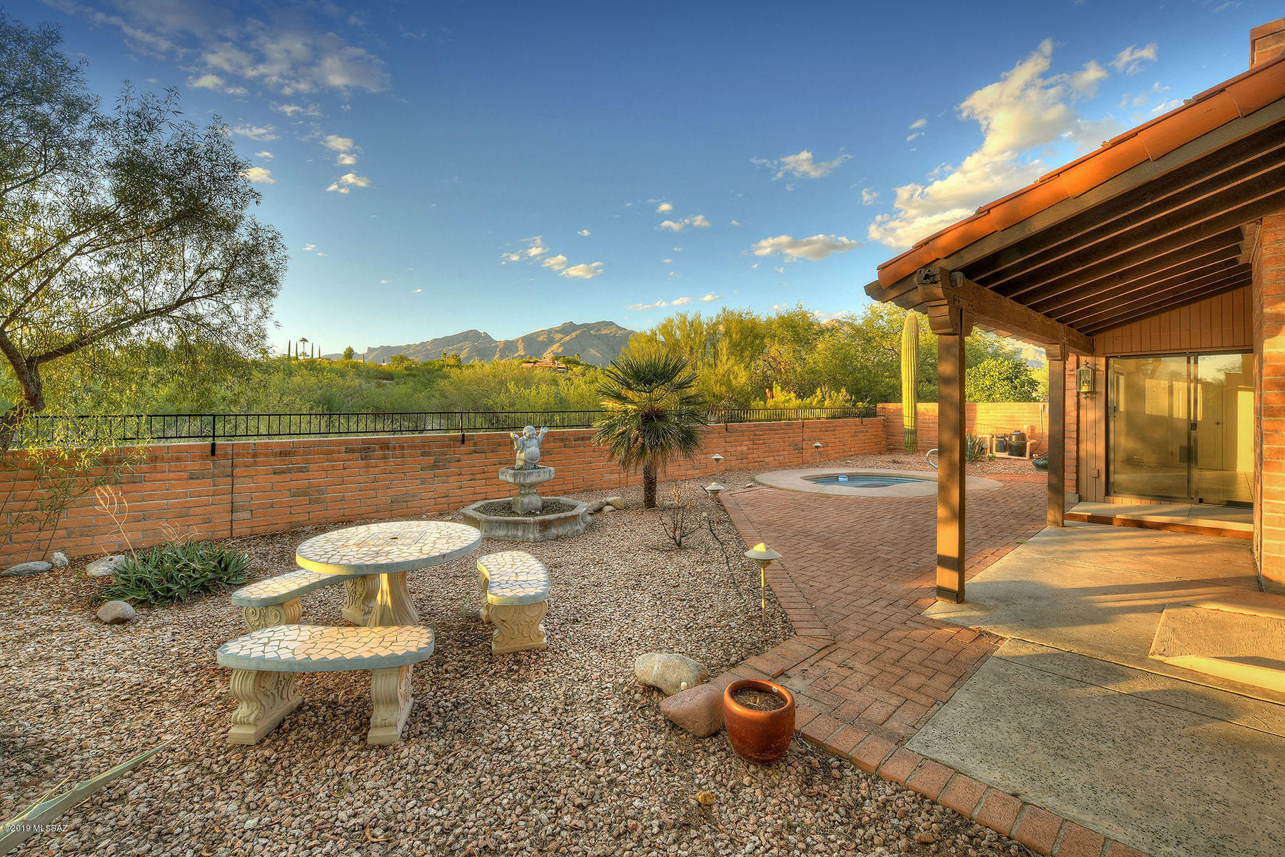3 bedrooms, 2 baths on a large lot. The backyard & side yard are low maintenance & beautifully landscaped with an in-ground spa. Wide open space behind the home will never be built on & adds privacy.  Sliding glass door from the eat-in kitchen leads to a screened in porch that opens to the backyard. You can see the mountains from the large living room with fireplace.  Huge master bedroom has an attached Arizona room for crafts or coffee. Renovated easy roll in master shower & handicap accessible. Wide doors & ADA compliant make this home desirable for everyone.