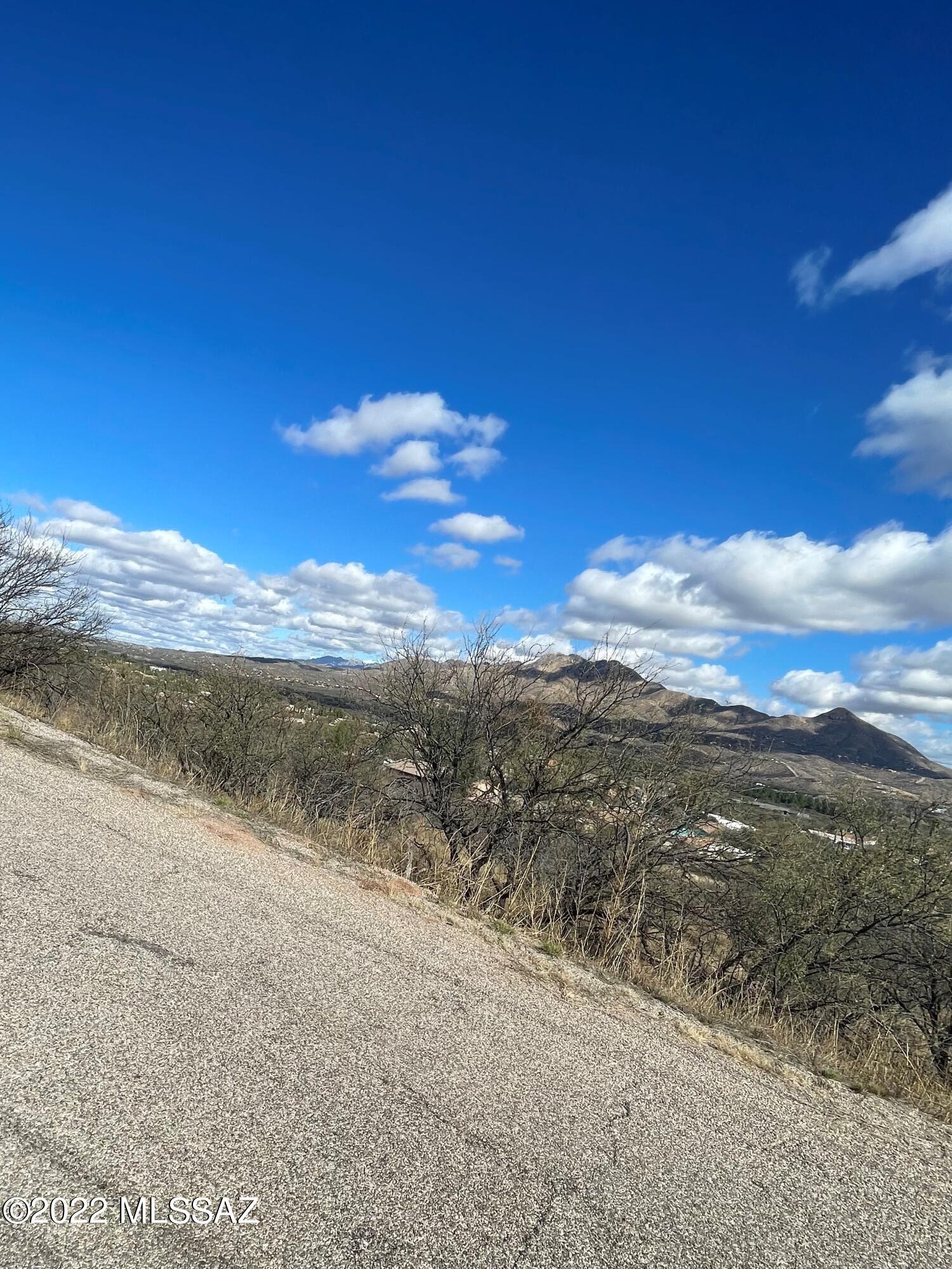 BEST VIEWS IN RIO RICO!  Overlooking the San Cayetano Mountain Range, this lot is 1.97 acres of land. Build your new home or weekend getaway on this property. Spectacular views of the mountains surround this picturesque, rural valley just over an hour from Tucson. East/west exposure and paved roads. Electricity pole and water are nearby. At 4600' elevation, fresh mountain air, blue skies, and cool breezes await.  Easy access to the freeway. Submit all offers!