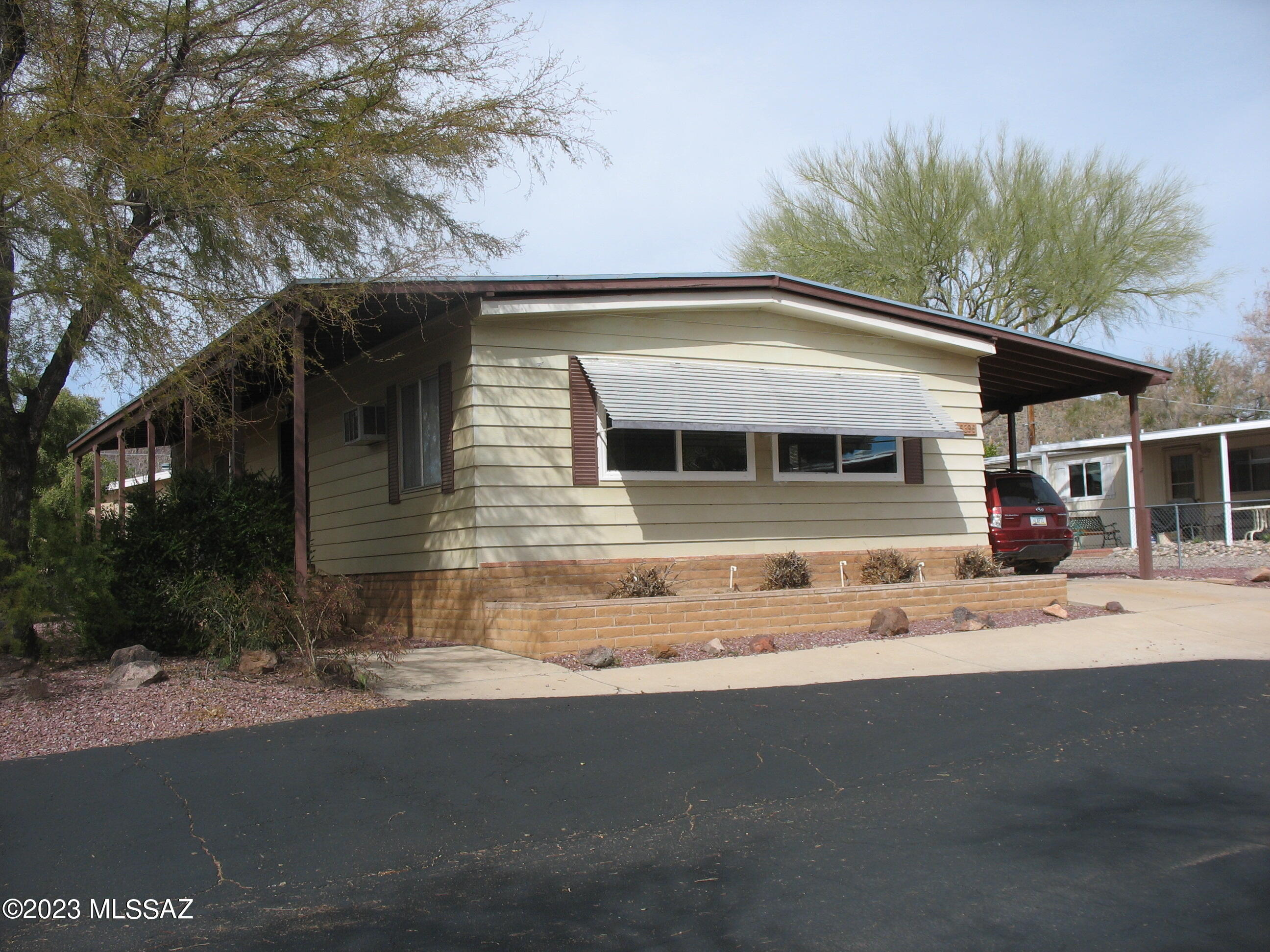 Very nice home on arroyo with fenced yard and mountain views! Gourmet kitchen with quartz counters and newer appliances. House has been re-piped with PEX plumbing. Roof was rebuilt in 2015. Culligan water softener. Newer laminate flooring throughout. Upgraded furnace with new digital thermostat. New windows in front on the street side. Large closet in the second bedroom. Slump block workshop in the rear. Citrus trees. And much more! The HOA fee includes unlimited golf, tennis, pickle ball, shuffleboard, pools, spa, exercise room, trash collection, and much more. You own the land!