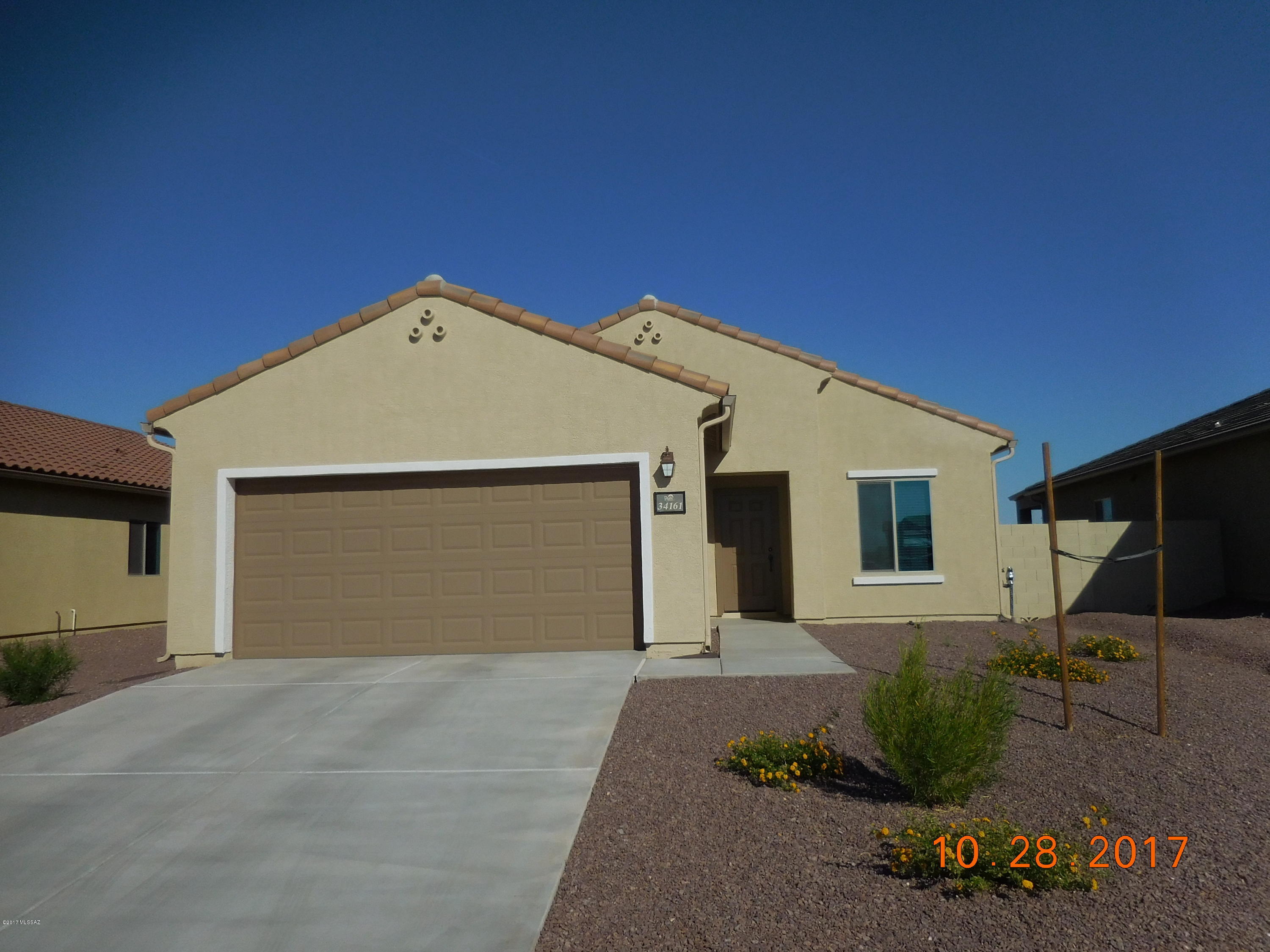 Want a New home? Here is one that is ready to go without the 4 to 6 months to get one built.  Only 4 months old!  Nice Ceramic tile in Kitchen and baths, light tan carpet, covered patio, and a two car garage.  No homes behind and in a great community with a community Park with a pool, spa, and other recreation areas.  Easy access off of I-10.  Still under the builder's warranty!  Get a new home without the wait.