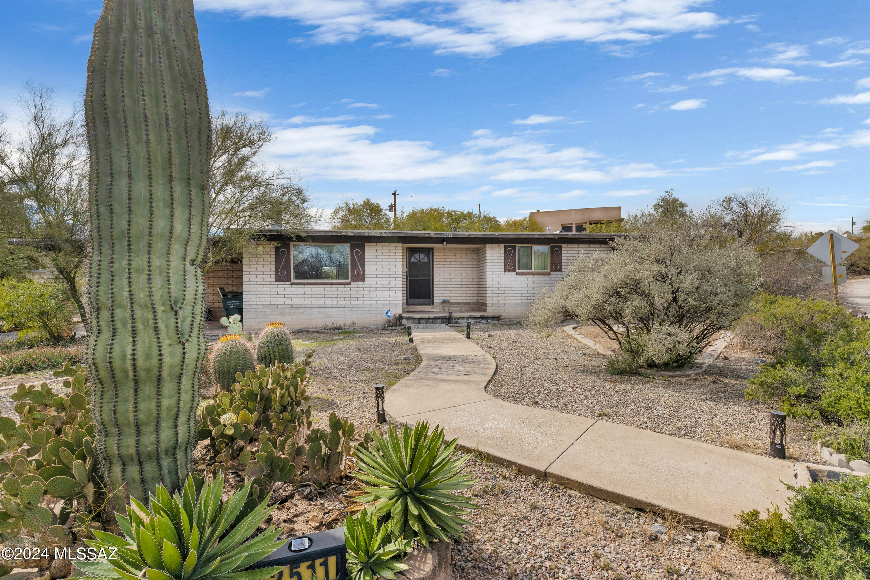 Discover the timeless allure of this 3-bedroom home, perfectly situated on a spacious 15,246 sqft corner lot with unobstructed mountain views. Nestled in a community with no HOA, this residence offers both privacy and freedom. The cozy family room, adorned with a fireplace, serves as the heart of the home, providing a warm and inviting atmosphere. With direct access to the backyard and carport, convenience meets charm. Step into the expansive backyard, where a symphony of shrubs and trees creates a natural oasis, offering shade and tranquility. With a perfect blend of classic design and scenic surroundings, this home is a timeless retreat for those seeking a balance of comfort and functionality!