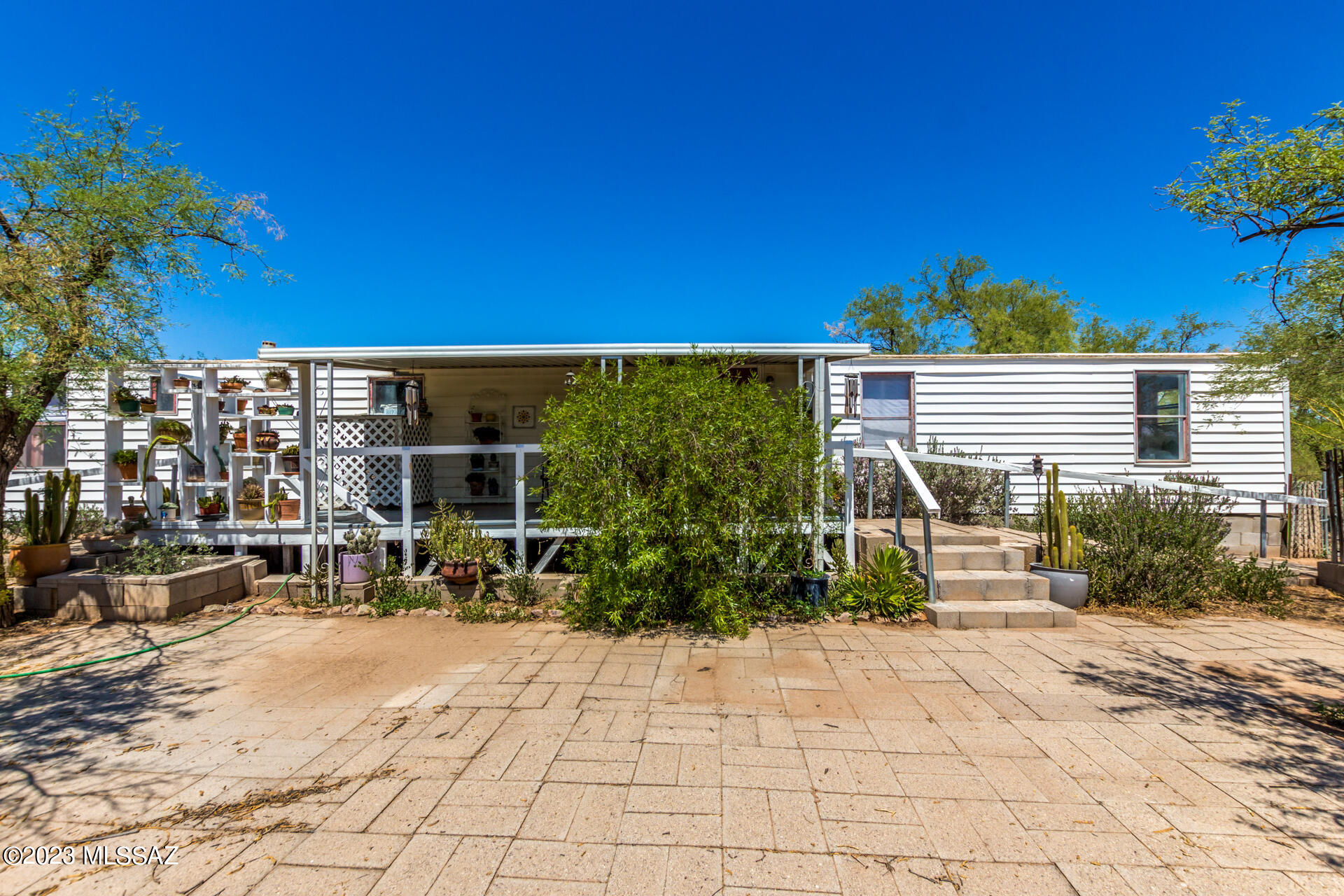 Nestled on over an acre fenced in lot, this delightful mobile home welcomes you with a unique circular driveway that provides convenience! Beyond the home lies an expansive backyard that's nothing short of a sanctuary! Offering a cozy deck, pavers, a greenhouse, & swaying shade trees. Owner owns both neighboring acre lots totaling 3.59 acres. All 3 parcels will convey with purchase (208-11-2240, 208-11-2250 and 208-11-2260) See map in photos