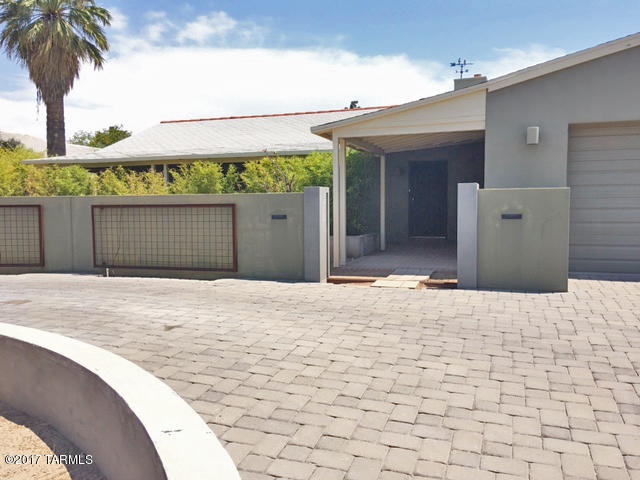 What started out as a charming bungalow was expanded by an addition in 2001 including a light & airy great room, beautiful & spacious kitchen that would make any cook’s heart jump for joy, a modern full bathroom w/ jacuzzi tub,large laundry room & garage. But,wait, there’s more… 1000 sq ft artist studio w/ north-facing windows (a real studio) that could be easily converted to a guest house; a lap pool and a greenhouse for the person w/ a green thumb. All in beautiful condition. New HVAC in 2016. Extra room in house used as an office (has fireplace). Studio has toilet & sink; plenty of room for shower. Very private and serene property just blocks from UA, medical facilities, restaurants and shops.