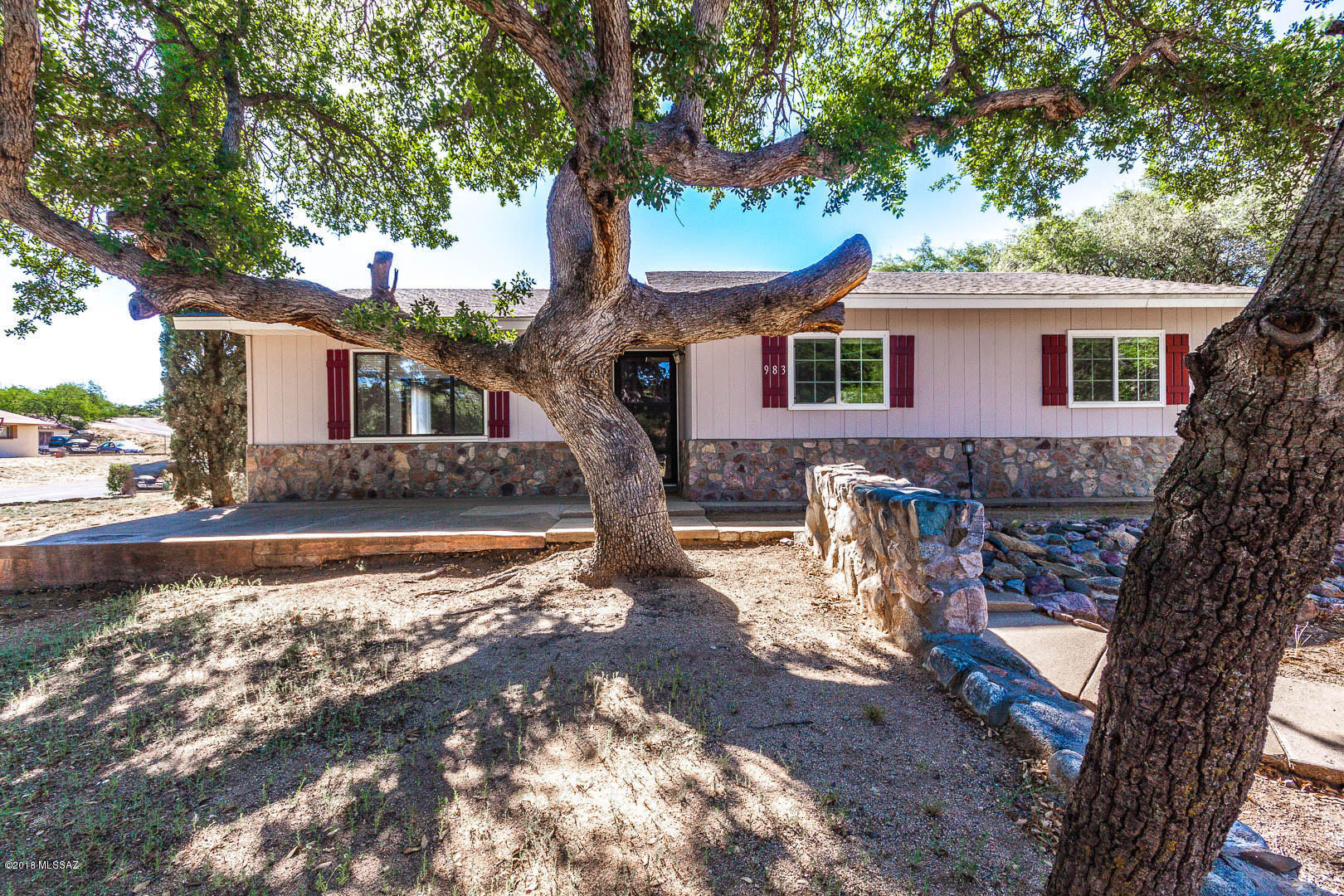 Charming light & bright 3 bedroom, 2 bathroom home on large corner lot with mature landscaping in beautiful Oracle, AZ. Enjoy the spacious family room and living room with cozy beehive, brick fireplace. Neutral carpeting throughout, brand new carpet in guest rooms. HVAC and paint. Open kitchen has stainless steel appliances. Large laundry room comes with washer and dryer.  Private master suite with vanity or desk area, large walk-in closet, dual sinks, tile countertops, walk-in shower and convenient access to private patio. Large guest rooms and updated guest bath with custom tile accents. Great corner lot with beautiful rock walls, three patios, mature trees, attached workshop. Room to park and RV. No homeowner's association fees.
