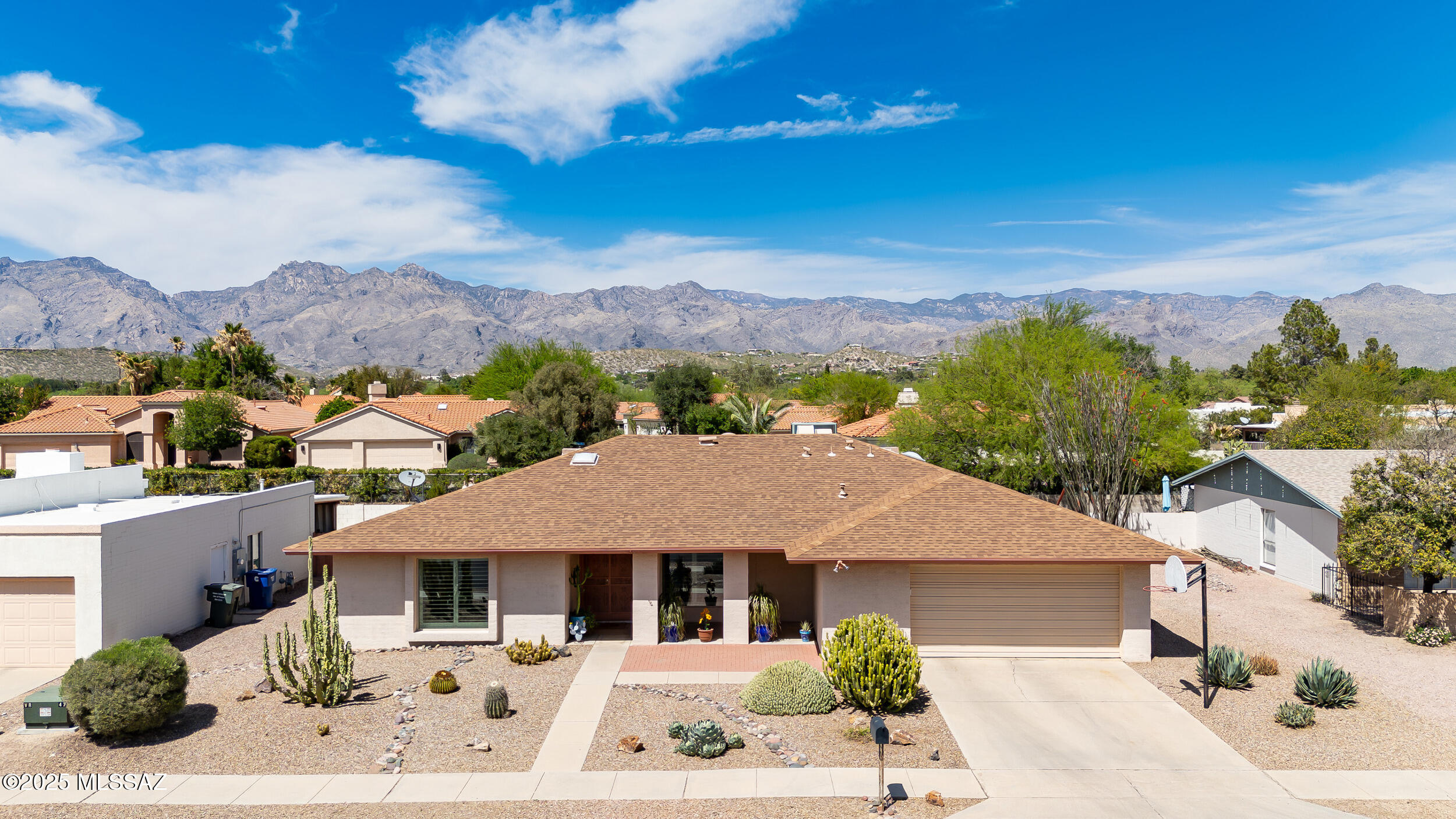 Beautifully upgraded 4 bed, 2 bath home with a 2-car garage, pool, and spa in the highly desirable Vista Del Rio community. This thoughtfully designed home features artificial grass, newer dual-pane windows, custom interior shutters, and recessed LED lighting in the living areas. Enjoy cooking in the updated kitchen with Corian countertops, a 2024 GE stainless appliance package (including gas cooktop with griddle), and a walk-in pantry. The north-facing backyard offers partial mountain views, perfect for relaxing by the pool or in the spa with a newer gas heater. HVAC is only 1.5 years old, and the home includes a cozy fireplace, 220 line in garage, newer water heater, and upgraded bathrooms with Talavera tile and executive height sinks. Double-door entry to owner's Suite. See floorplan for bonus room off Owner's Suite.  Located on a peaceful street with sidewalks, walking trails, and access to The Loop. Inside the subdivision, you'll enjoy a historically significant 3.88-acre natural parkdedicated in 2004 and maintained with support from the Tohono O'odham Nationplus a separate community playground. The 2-car garage includes a newer opener and built-in storage. Pet lovers will appreciate the built-in doggie door. The neighborhood is well-known for its festive Halloween spirit and decorations. Conveniently walkable to Udall Park, Frost, Zona 78, Dogtopia, Safeway, Walgreens, and more at Tanque Verde & Sabino Canyon. This home truly offers comfort, style, and community in one amazing package!