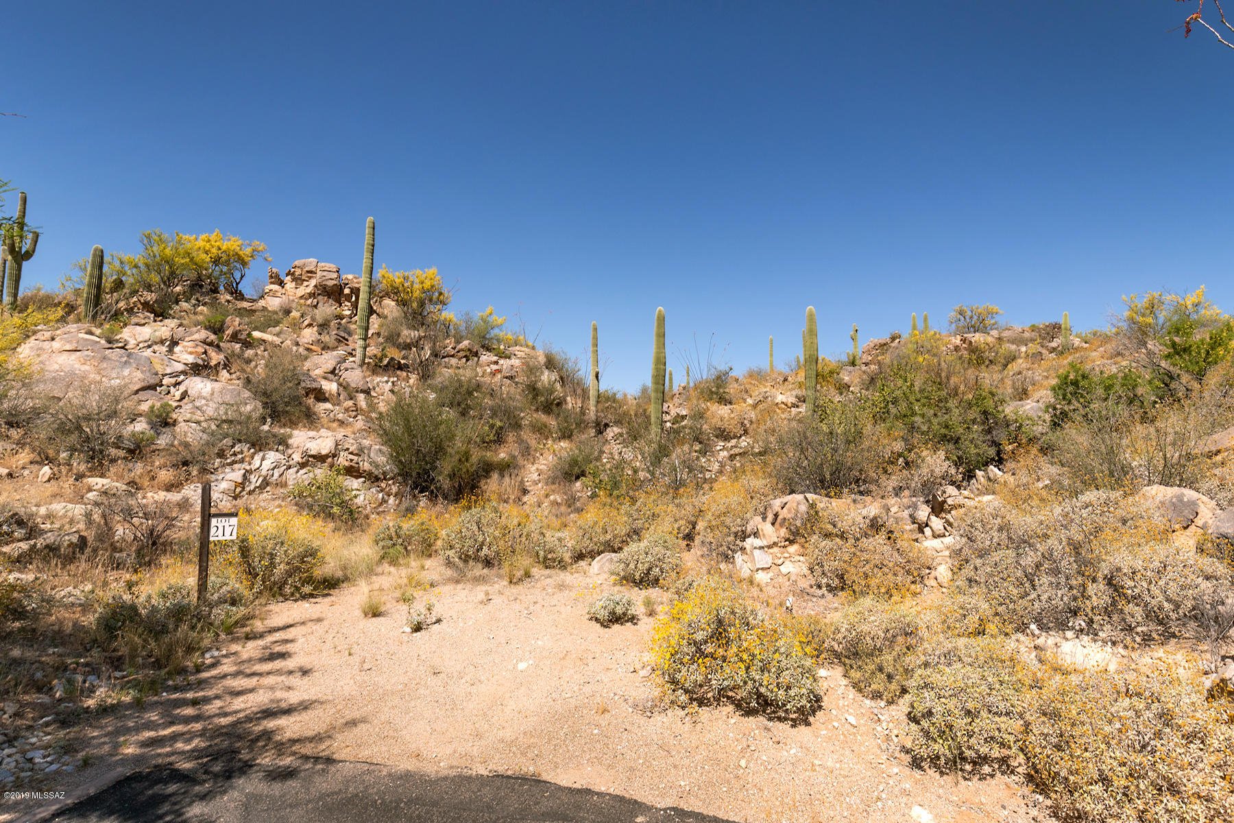 Great homesite surrounded by views, majestic landscape and rock outcroppings. Located in exclusive gated community of Stone Canyon offering championship golf course, swim, tennis, fitness center and clubhouse. Country club living in a desert oasis.