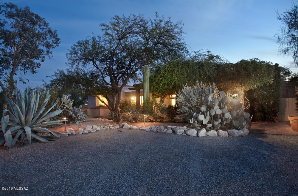 Classic Tucson Adobe home in neighborhood conveniently located 5 minutes to the best restaurants and shopping in Tucson. Updated home with spectacular city and mountain views. Antique doors into the master bedroom and luxurious bath, all looking out to a beautiful pool. Viking dual fuel double oven stove, imported French tile and concrete counter tops made in San Francisco create a warm and inviting kitchen.The garden offers just enough lawn for children to enjoy, roses for your vases,and dogs to roam. A great outdoor entertaining space in which to bbq, canopied by mature trees. This home has been loved and lovingly cared for by the owner. House has contemporary lines ...currently filled with antiques, but just as suitable for modern furniture. **4th bdrm being used as  den/office