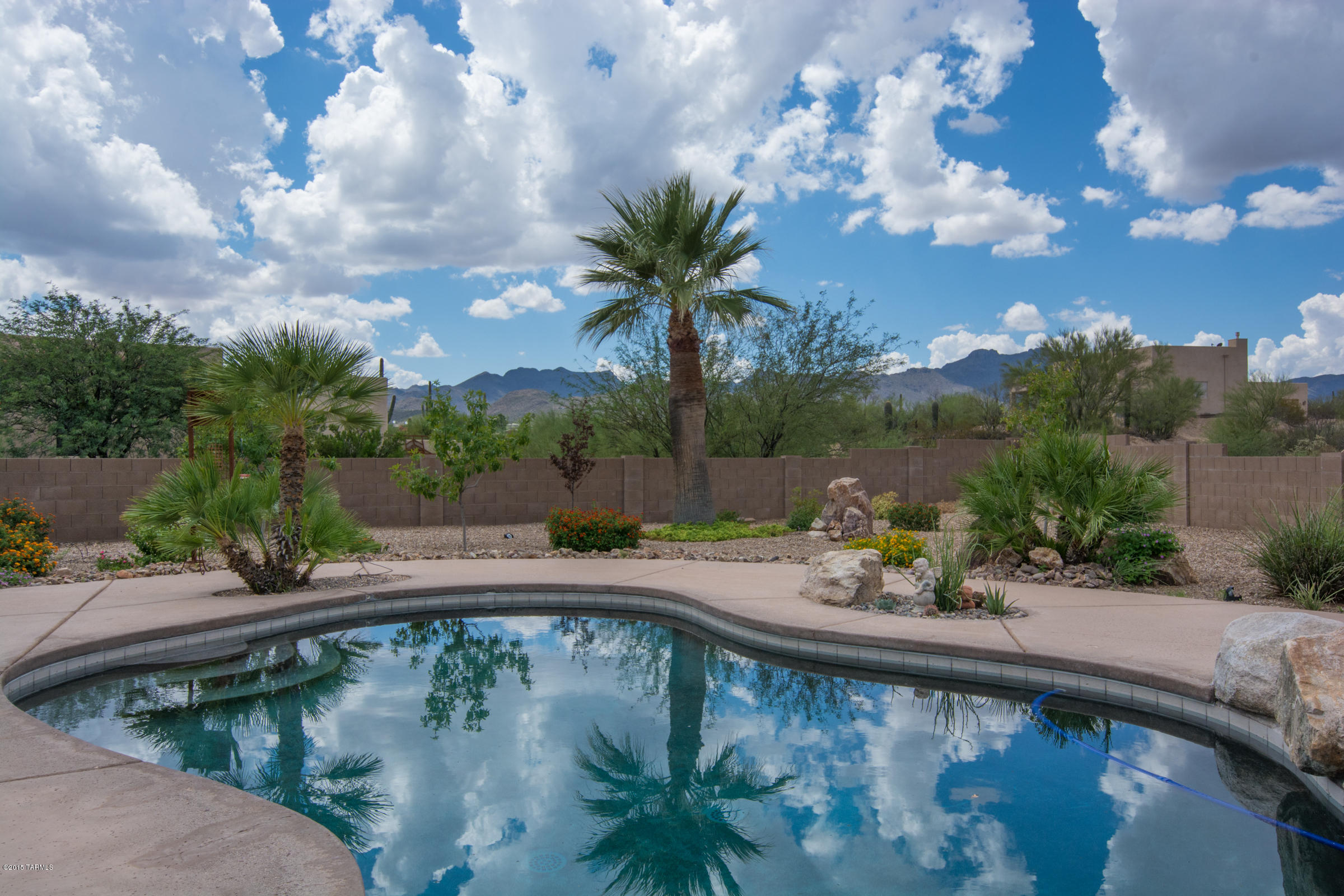Gorgeous! Extra Large Premium Cul De Sac lot surrounded by open desert area w/no connected neighbor. Exquisite African Violet slate tile flrs thruout w/neutral carpet in 3 of 4 bdrms. 4th bdrm w/French doors may serve as home office. Formal living/dining currently set up as exercise rm. Kitchen boasts hi end light fixtures, superior grade granite slab counters w/full granite splash, warm maple cabinets w/pullouts, newer stainless steel appliances w/5 burner gas range. Breakfast bar, plus breakfast area off kitchen opens to spacious family rm. w/stunning view of pool & perfectly manicured garden providing expansive space for entertaining. Oversized garage. Enjoy mountain views & spectacular sunsets by day w/endless star gazing by night! A pleasure to show! Virtual Tour at Photo Tab.
