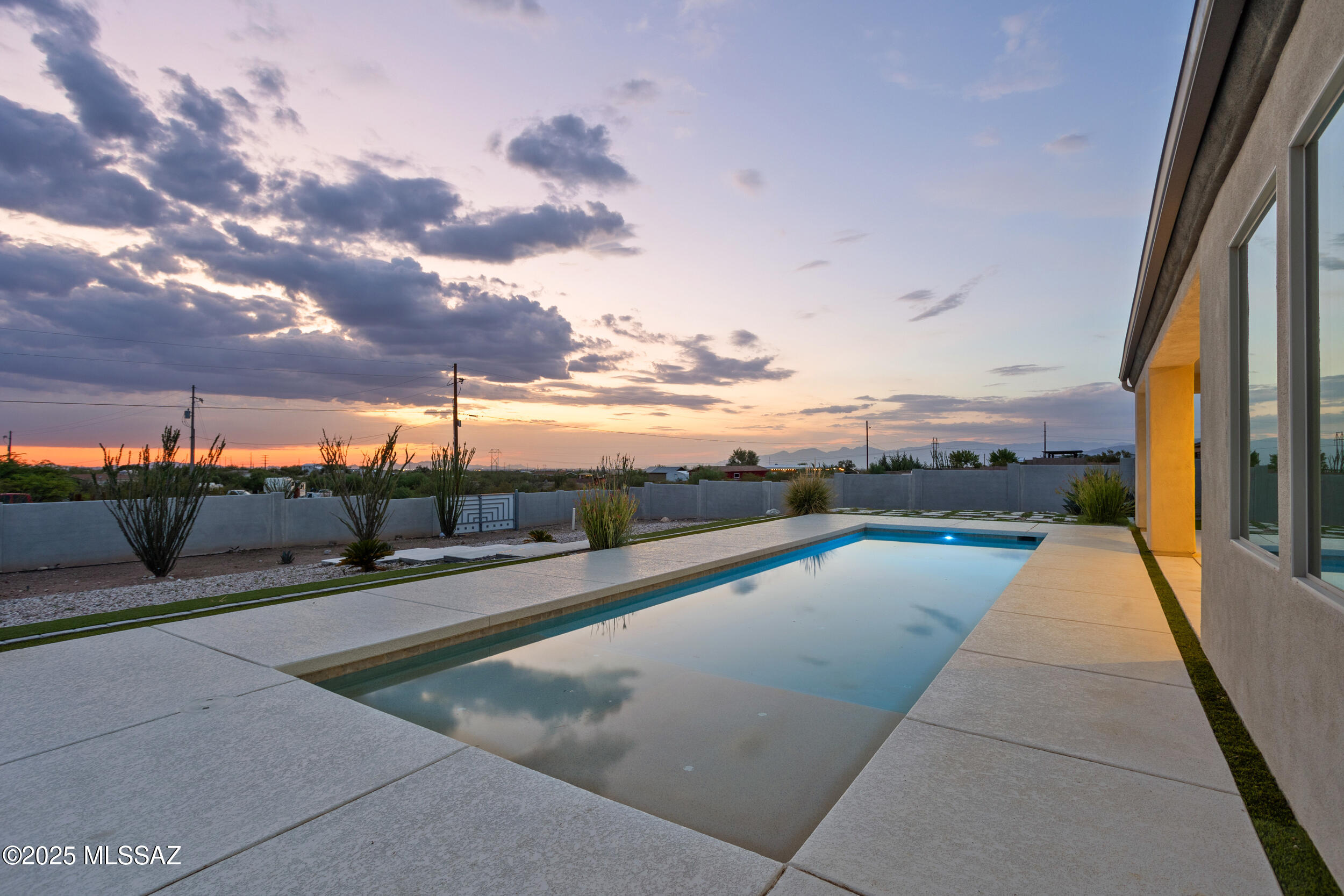 NEW YEAR, NEW PRICE! STUNNING 3BD + DEN, SINGLE-STORY home on .92 ACRES w/POOL, SOLAR, & RV PARKING! Versatile DEN can easily serve as 4th BDRM. As you enter through the grand double doors you're greeted by 12ft ceilings, ceramic tile flrng, & lrg PICTURE WINDOWS that flood the space w/natural light & provide GORGEOUS VIEWS of the BEAUTIFUL SPARKLING LAP POOL w/an in-floor cleaning systm. Enjoy BREATHTAKING SUNSETS from the expansive backyrd where you'll also find a custom wrought iron double gate for your large toys. Other features include 8'doors, gourmet kitchen w/granite counters, glass mosaic backsplash, lrg island w/pendant lighting, lrg primary suite w/dual vanities, walk-in shower, garden tub, huge closet, whole-house water softnr, & 3car garage + extended driveway. Tucked away in a quiet cul-de-sac and located within the highly acclaimed Vail School District - the #1 performing school district in Tucson, AZ! Minutes from I-10 making dining, shopping, and work in Tucson a short commute.