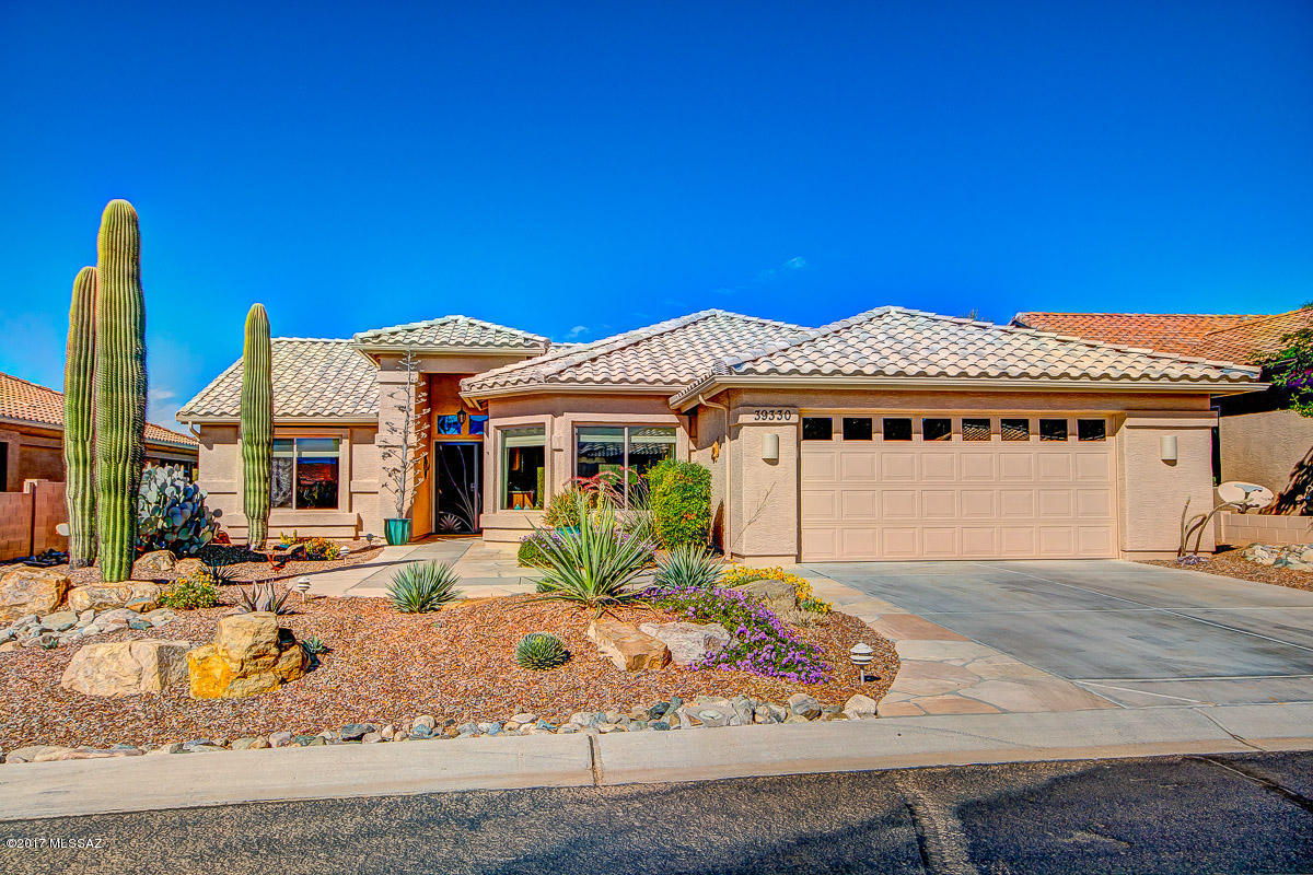 Charming & meticulously maintained Laredo model, sited on a very private lot that backs to natural open space w/no homes behind.  This home was built using 2x6 construction & extended 2 feet on the entire south side, affording a larger guest bedroom, bath & office/den! The many upgraded features include a large double door pantry, gorgeous granite topped kitchen counters, stainless steel appliances, neutral colored tile throughout, bay windows in breakfast nook and master bedroom, IKEA closet organizers in large walk-in master closet, comfort height Toto toilets in both baths, lovely Southwest decorator colors & honey comb shades, plus storage cabs, utility sink & work bench in garage.  Relax on the extended flagstone patio and enjoy beautiful unobstructed desert scenery.