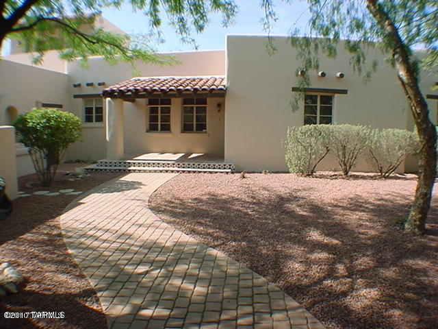 Beautiful Santa Fe style Hacienda, luxury living for working or going to school! Close to UA and UMC Banner! Features, 5 bedrooms, 4 baths, hardwood floors, cozy fireplace, jacuzzi tub, private courtyard and large backyard and covered patio. Includes 2 car garage