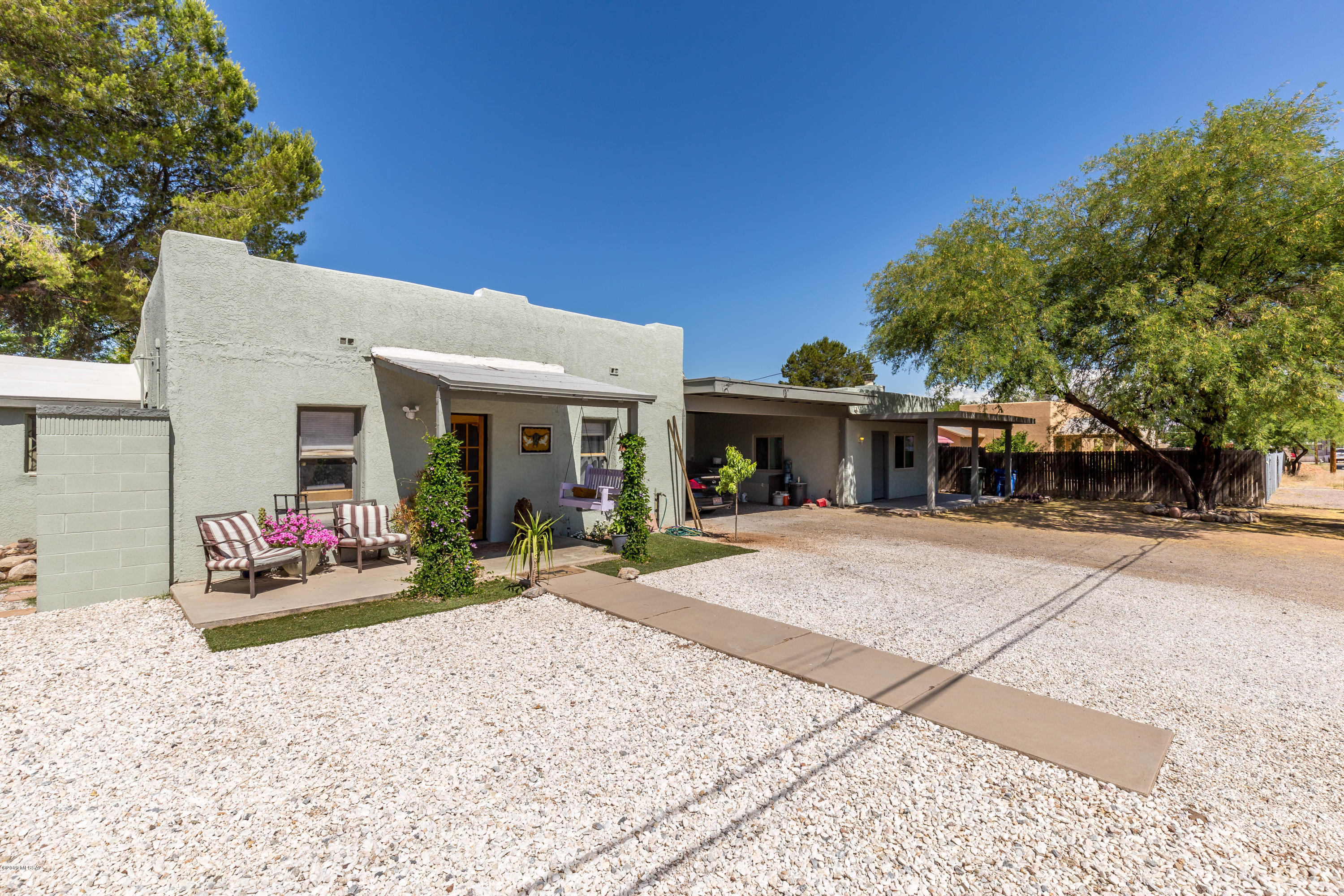 Beautifully remodeled 3 1-1/2  house in central Tucson with charming 2-1 mud adobe guest house! Main house remodeled from top to bottom inside with all new kitchen appliances and wood burning fireplace in living room! Both structures make good use of the lot and have separate fenced back yards with covered patios, guest house has brand new chimnea fireplace in back yard. Off street parking with carport connecting both units. Come see!
