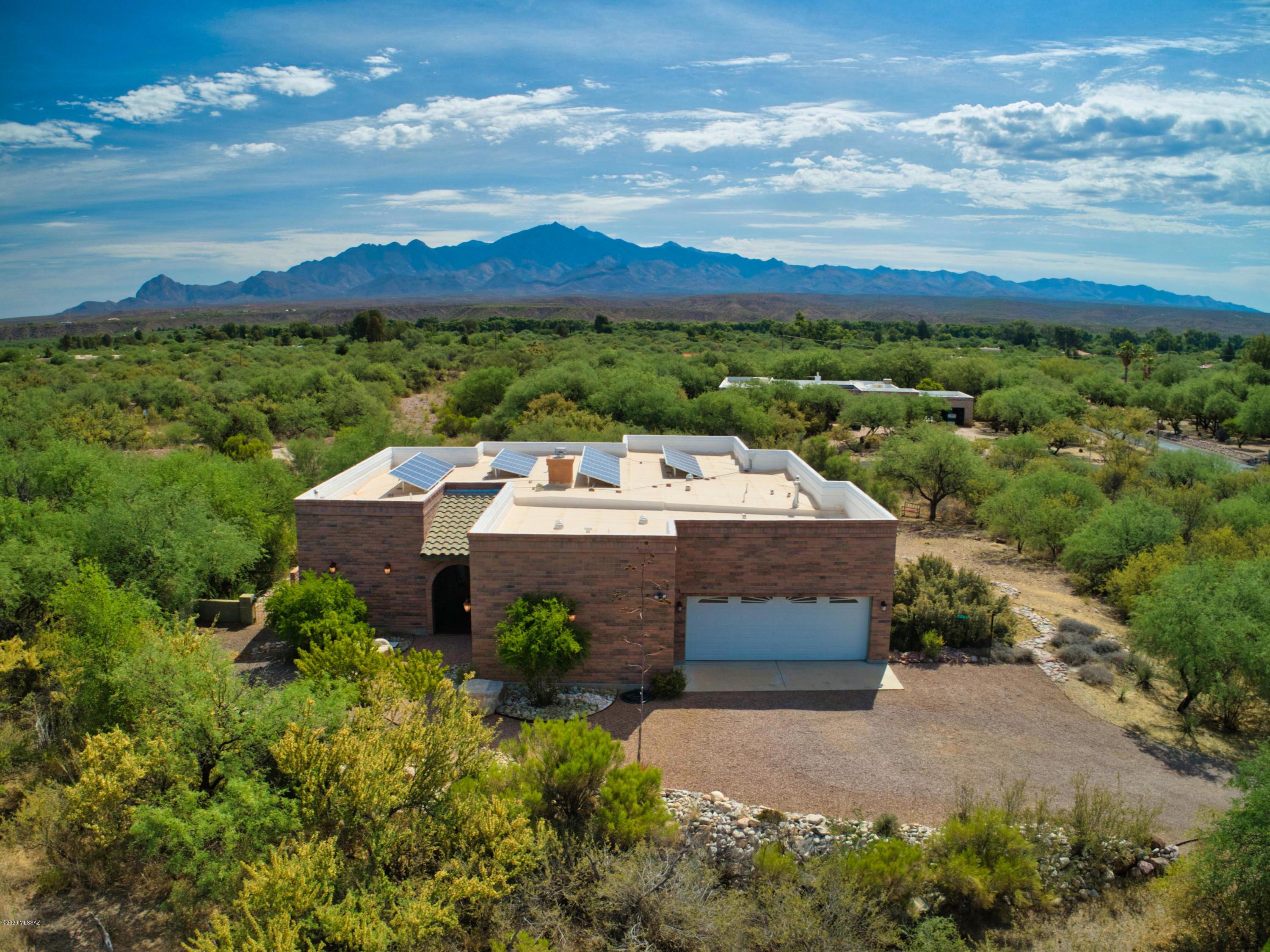 Unlimited Views and privacy in the desirable Tubac Country Club Estates.  The spacious living areas have high ceilings. Large windows and sweeping views.  Relax on the deep covered porch with morning coffee or watch the Santa Rita Mounts turn pink in the late afternoon.  This beautiful home was built with a small environmental footprint in mind.  Constructed with low-e windows, high insulation values and outfitted with solar panel system.  There have been no net electrical usage since 2010.  Much of this .96 acre property has been left undisturbed allowing for numerous bird species and abundant wildlife.