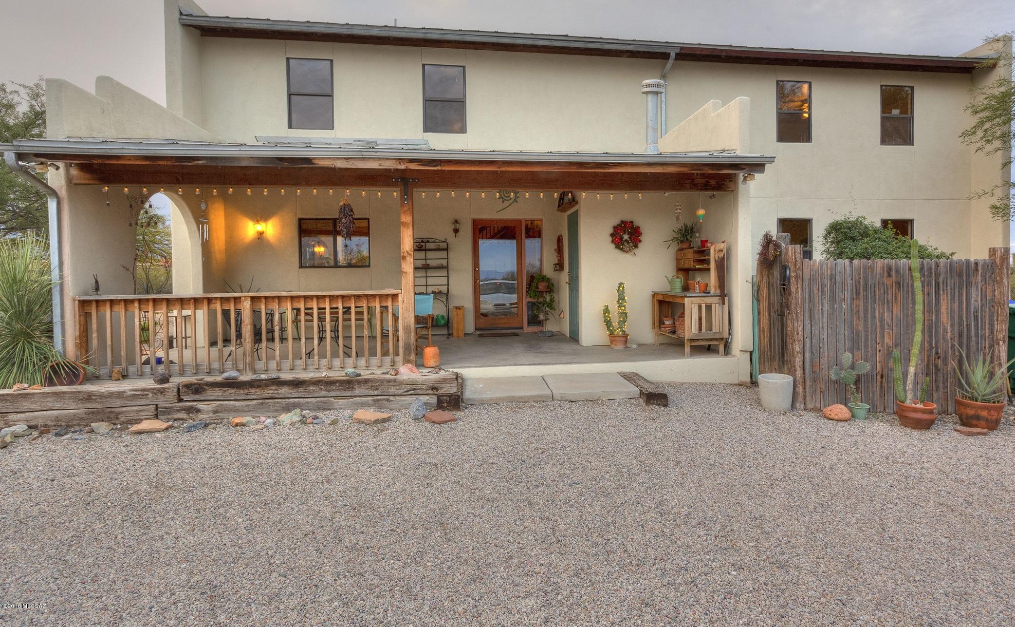 Custom Spanish Mission style home with charming rustic character! 3046 sq ft open concept great room full of natural light, a loft with built-in shelving, perfect for an office or a place for the kiddos to hang out, 4 spacious 12'x23' bedrooms with en-suites. Plus a half bath! Panoramic mountain views! Sip your coffee and enjoy the sunrises from your outdoor patio. Relax and watch the spectacular Arizona sunsets from your upstairs exterior balcony! Spacious metal garage/workshop with cement slab, metal roll up door and shelving. Fenced area behind the garage offers additional storage or makes a great place for the pups to hang out! Horse facilities include: arena, stalls, turnouts along with  two 14'x 16' storage buildings for tack, hay and equipment. Fully fenced property and so much more