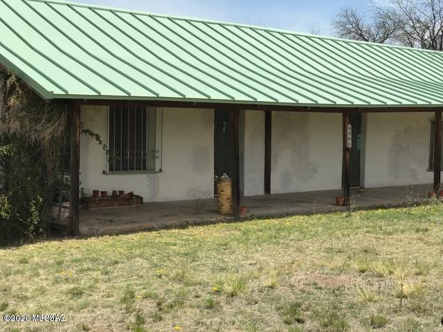 Rich in Tumacacori history & character this pre-1900 adobe home has B-2 commercial zoning, creating rare ''live & work'' benefit as it did in the pioneer days. Roll up your sleeves & get to work restoring this gem. Wonderful covered front porch w/ mountain views. Healthy Tubac tourist traffic. So much potential w/ built-in charm, beautiful fireplace, saguaro ribbed ceilings, plastered walls, Mexican tiled bath.  Great kitchen to gather in w/ wood burning stove for atmosphere & screened in Arizona room for summer. Newer standing seam metal roofing  &  upgraded electrical.  1/3 share in existing well. Septic install 1996. SALE AS-IS. Seller is unable to make any repairs. NO SPDS- Seller never lived on the property. Older water heater leaked damaging utility & bedroom wall. Appliances as-is.
