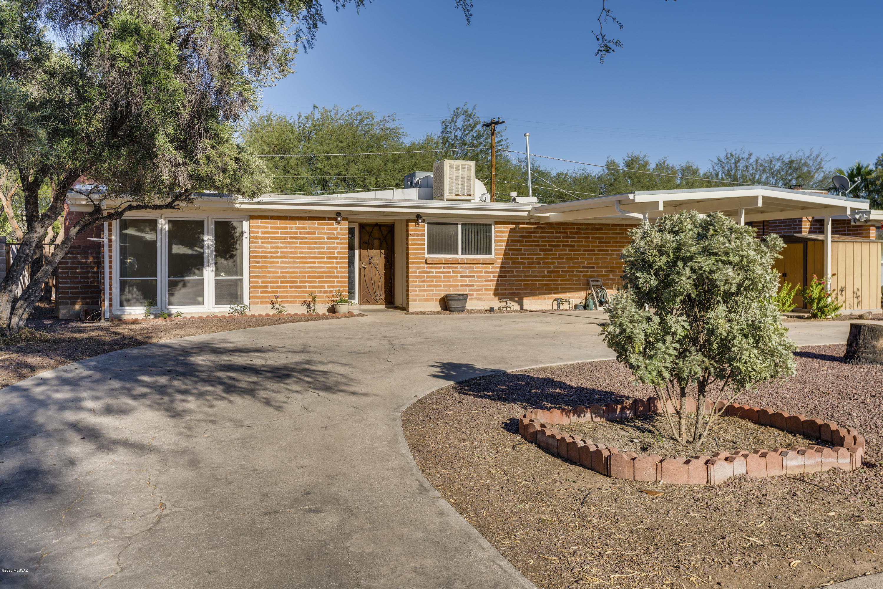 3 Bd/ 2 Bth  adobe with living and family Room.  Family room has additional outside entrance and could be used as additional bedroom/living quarters.  Beautiful exposed adobe, fireplace in living room. Kitchen has stainless steel appliances, granite counters and large walk-in pantry.  Landscaped private backyard with sparkling pool.