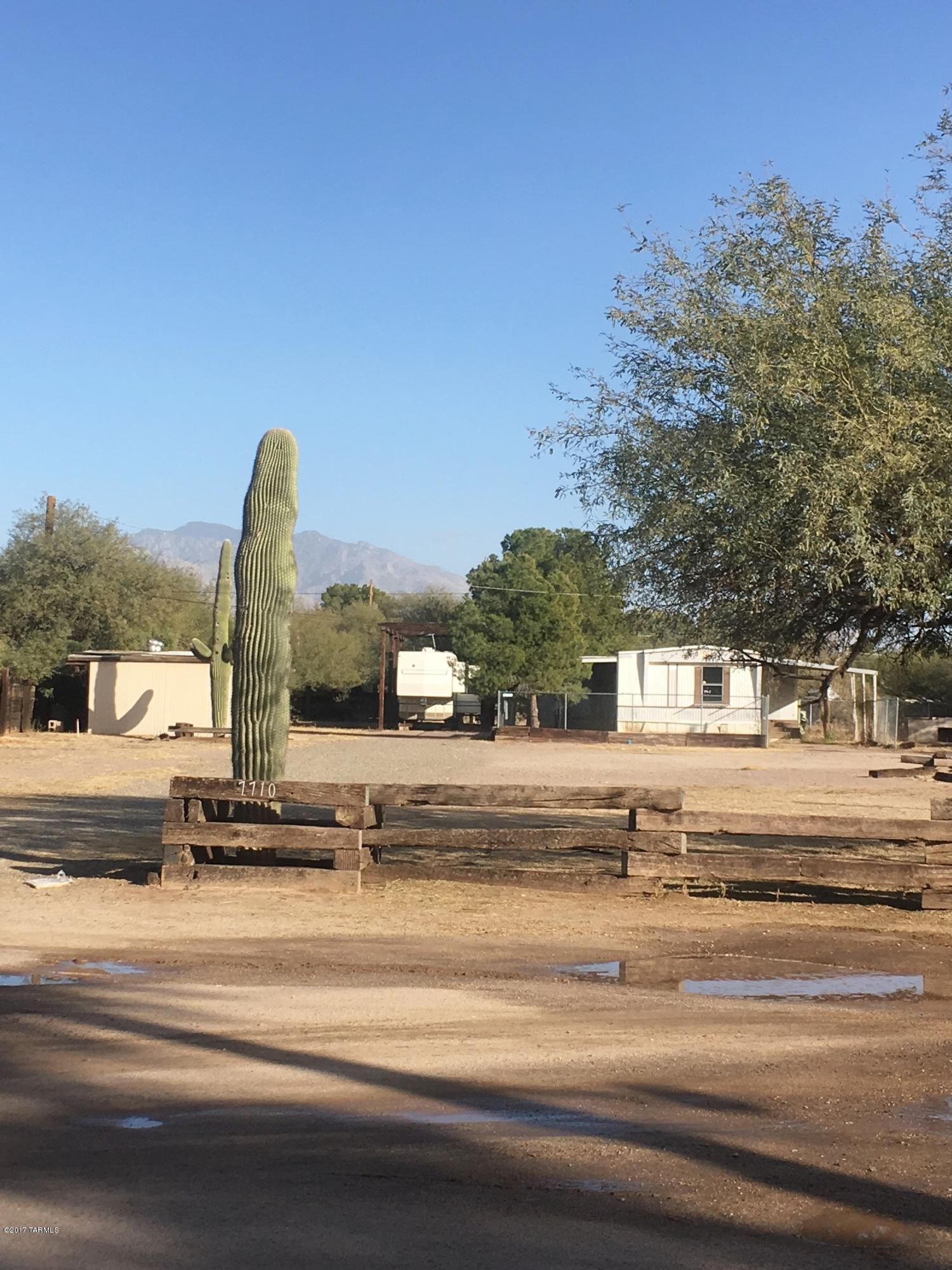 Acre lot with older 3 bedroom 2 bath MH plus addition, needs work.   Last rented $825. RV lot up front will rent for $300. Property inherited, do not know the condition, no SPDS. Past owner kept 5th wheel on property for his use when in town.  5th wheel RV still on property hooked up to utilities, could be purchased with the property. Could move up front lot and rented or?? Live on property and have rental.  Property zoned for two living units MH, RV or Homes. Water $20 per unit per month